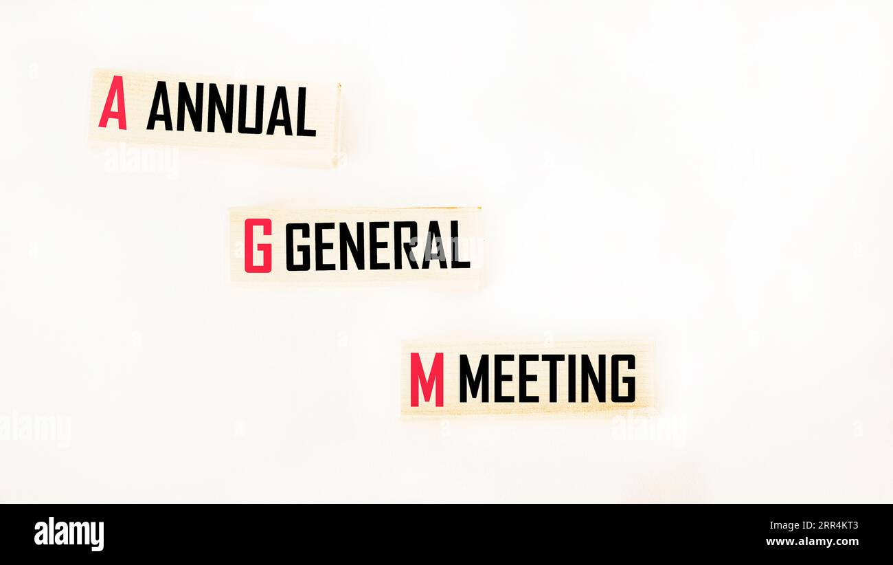AGM is the AGM symbol on wooden cubes and a white background. The concept of business and the annual general meeting of shareholders. Copy space. Stock Photo