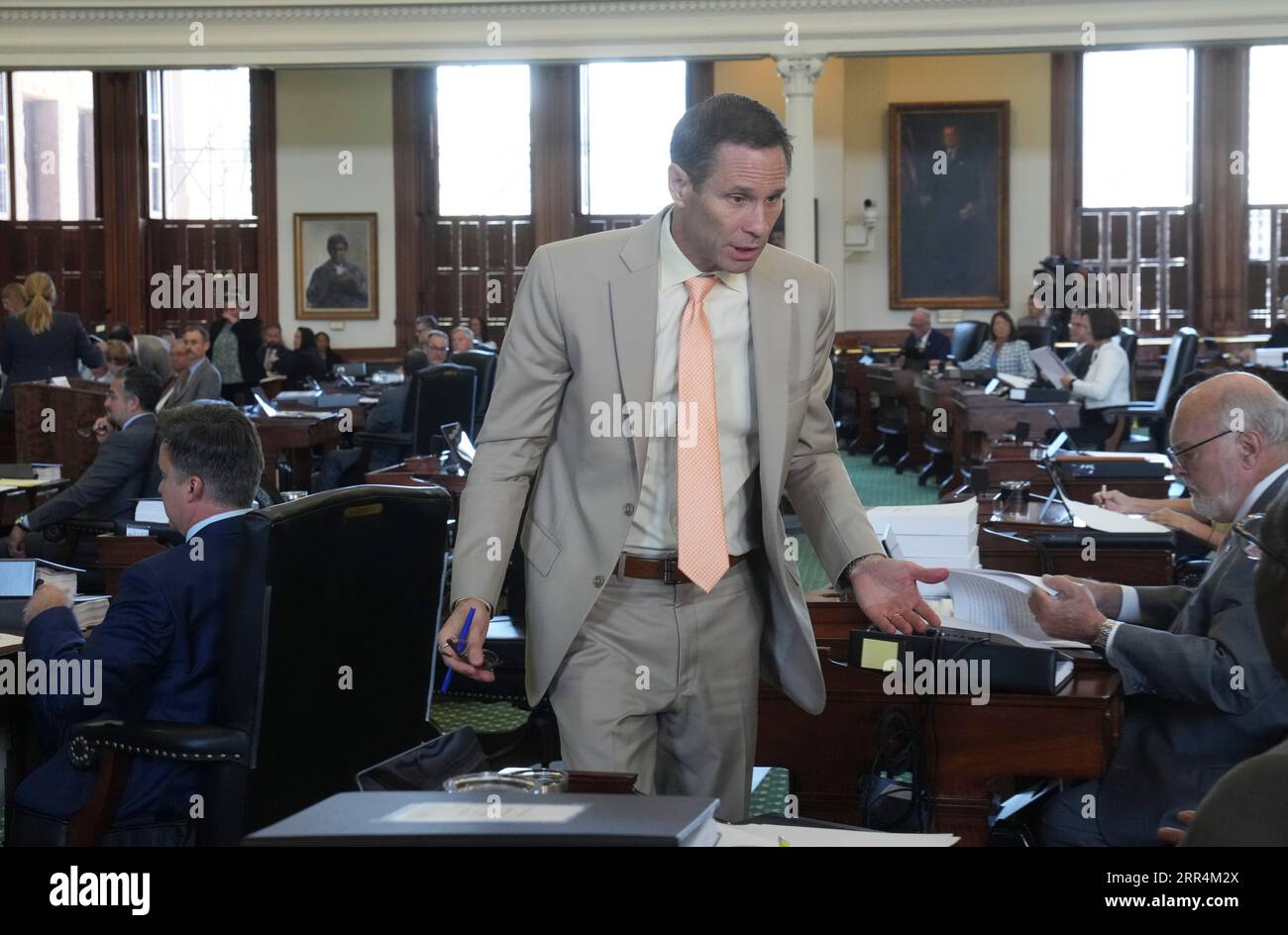 Sen Nathan Johnson talks with a colleague during the morning session of Texas Attorney General Ken Paxton's impeachment trial in the Texas Senate on September 6, 2023. Credit: Bob Daemmrich/Alamy Live News Stock Photo