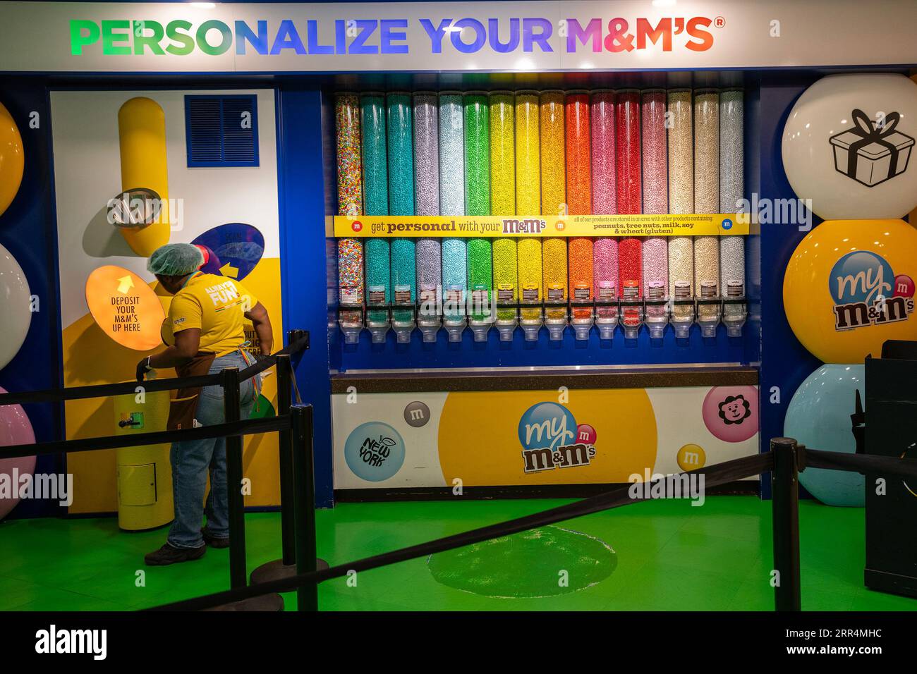 New York, USA - July 22nd, 2023: Dispensers full of various colors and tastes of candies in an M&M's store in New York. Stock Photo