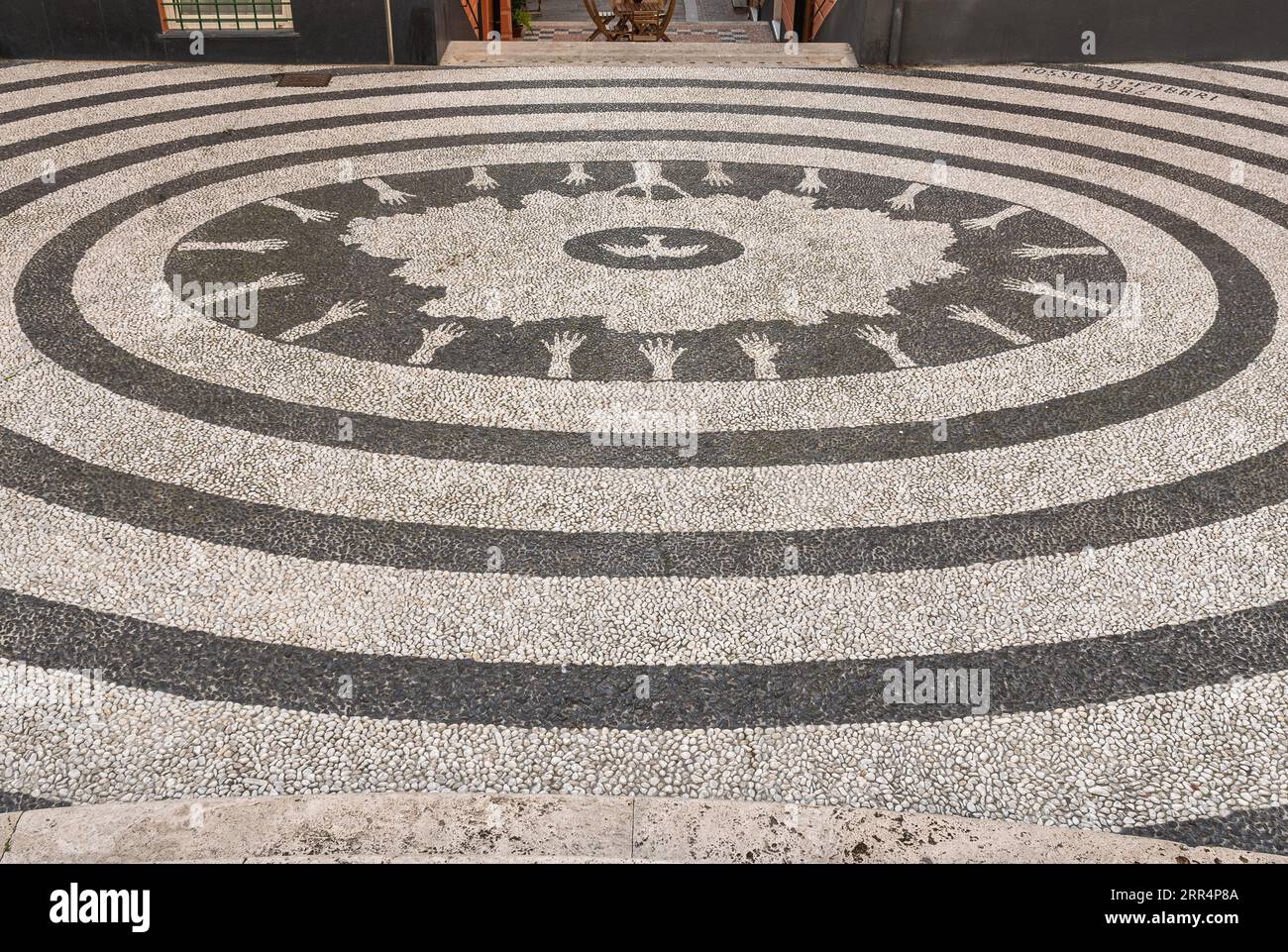 Churchyard of the Church of Nostra Signora della Concordia, with a black and white pebbles pavement in a concentric pattern, Albissola Marina, Savona Stock Photo