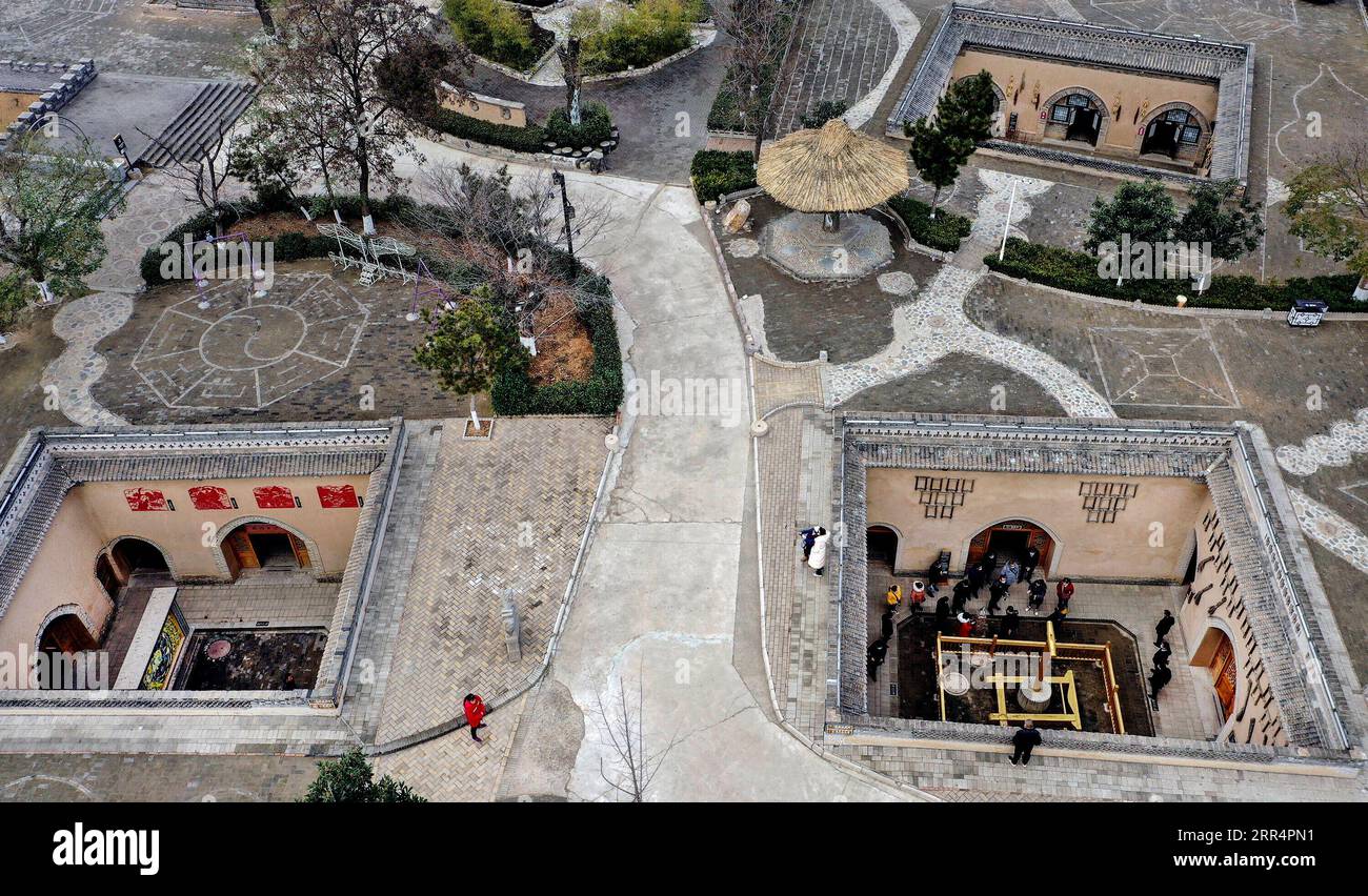 201211 -- SANMENXIA, Dec. 11, 2020 -- Aerial photo taken on Dec. 10, 2020 shows tourists visting traditional Dikengyuan residences in Beiying Village, Zhangbian Township, Shanzhou District, Sanmenxia City of central China s Henan Province. The Dikengyuan residence, a traditional residential construction in west Henan featuring a sunken courtyard, is of high value in the study of local history, architecture, geology and sociology. It was listed in the third batch of China s national intangible cultural heritage in 2011. Many of these residences in Shanzhou District have been renovated and turne Stock Photo