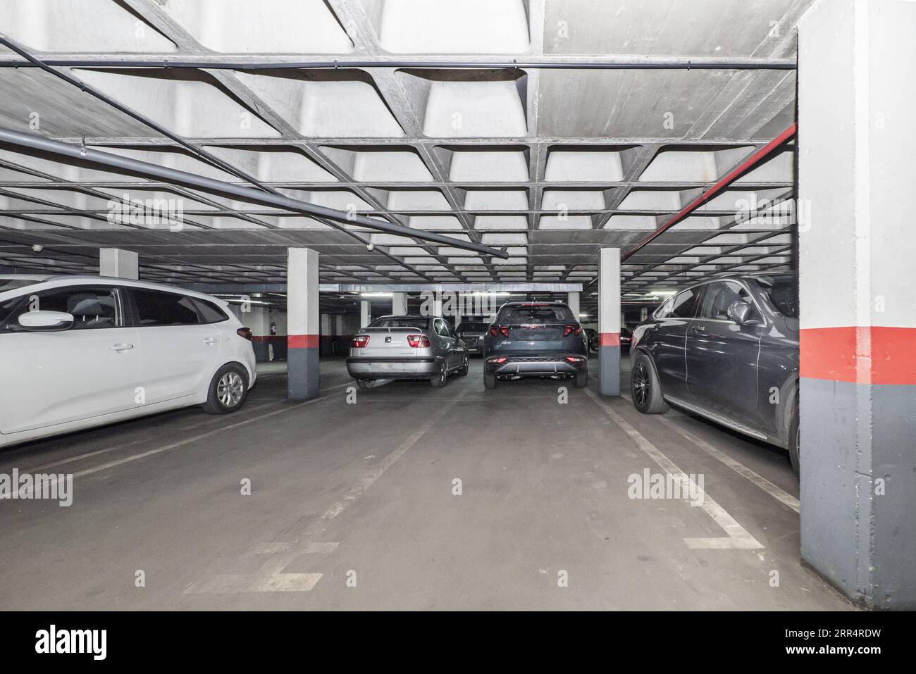 Parked cars and empty spaces in an underground garage Stock Photo