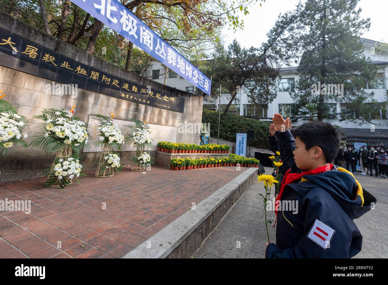 201213 -- NANJING, Dec. 13, 2020 -- Members of the Chinese Young Pioneers salute in front of a monument in commemoration of victims of the Nanjing Massacre at a mass burial place on the occasion of the seventh national memorial day in Nanjing, capital of east China s Jiangsu Province, Dec. 13, 2020. Photo by /Xinhua CHINA-NANJING MASSACRE-COMMEMORATION CN DuxYi PUBLICATIONxNOTxINxCHN Stock Photo