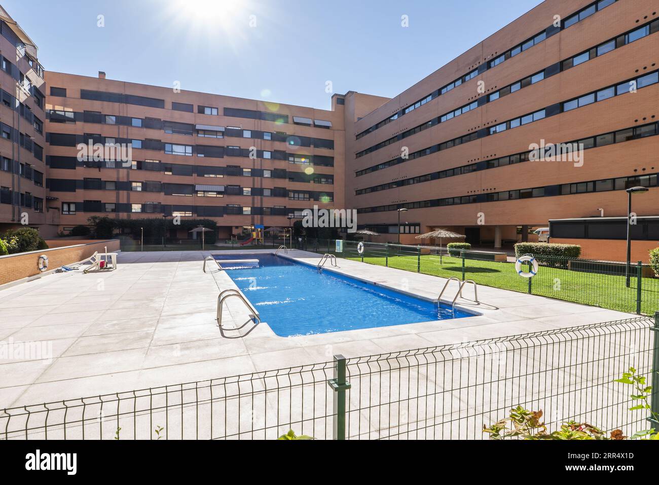 Community summer pool with fenced perimeter within the common areas