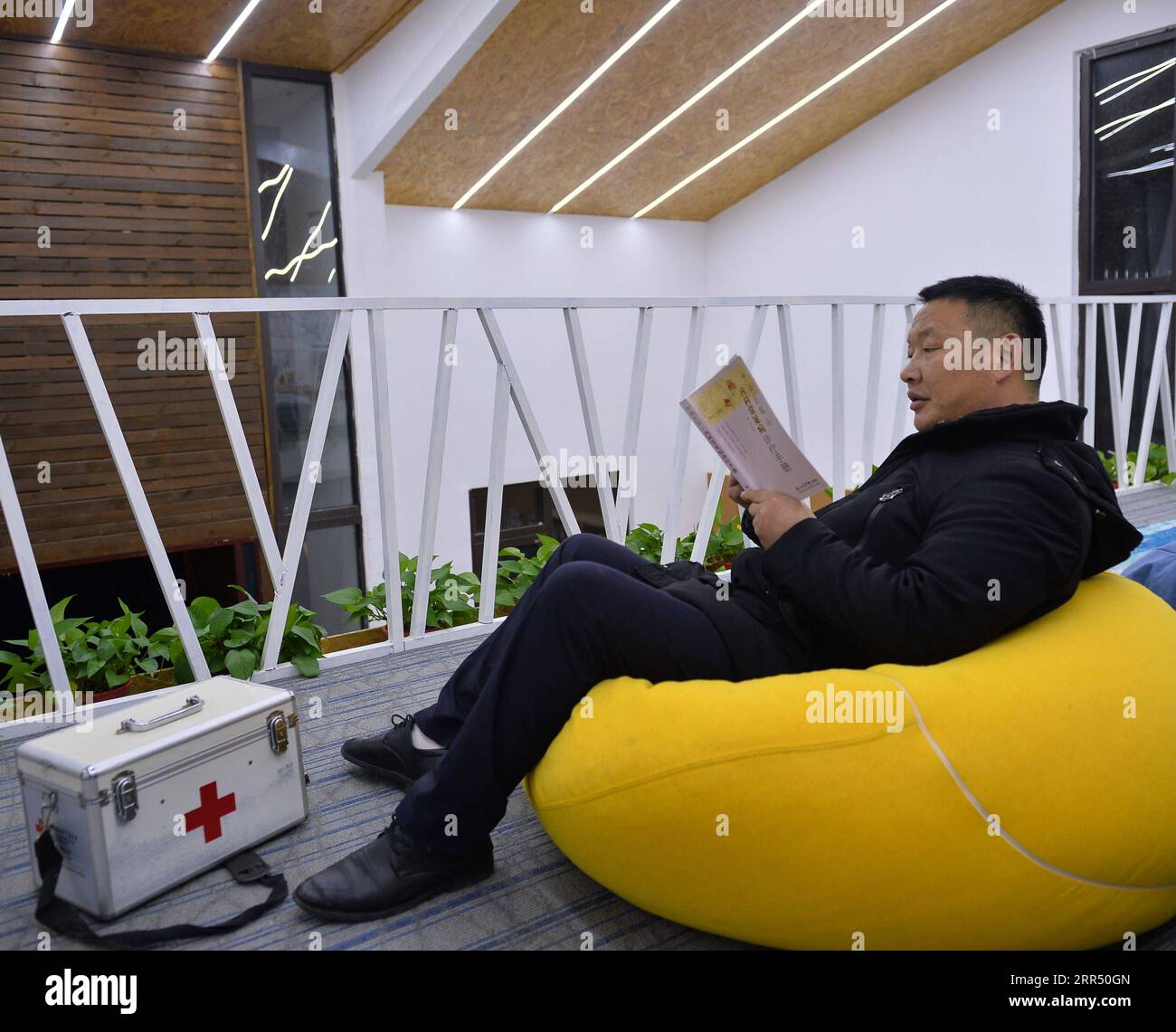201218 -- JINZHAI, Dec. 18, 2020 -- Yu Jiajun reads a book at the new health station in Jinzhai County of Luan City, east China s Anhui Province, Dec. 15, 2020. Deep in the Xianghongdian Reservoir area in Jinzhai County of Luan City, east China s Anhui Province, there is an isolated island, which used to be home to over 40 poor families. Yu Jiajun, 42, is the only doctor in the village. In the past, there was no health station on the island. Villagers had to row a boat for two or three hours to go to the health center in Mabu Township to see the doctor. Yu said. When Yu Jiajun returned to the Stock Photo