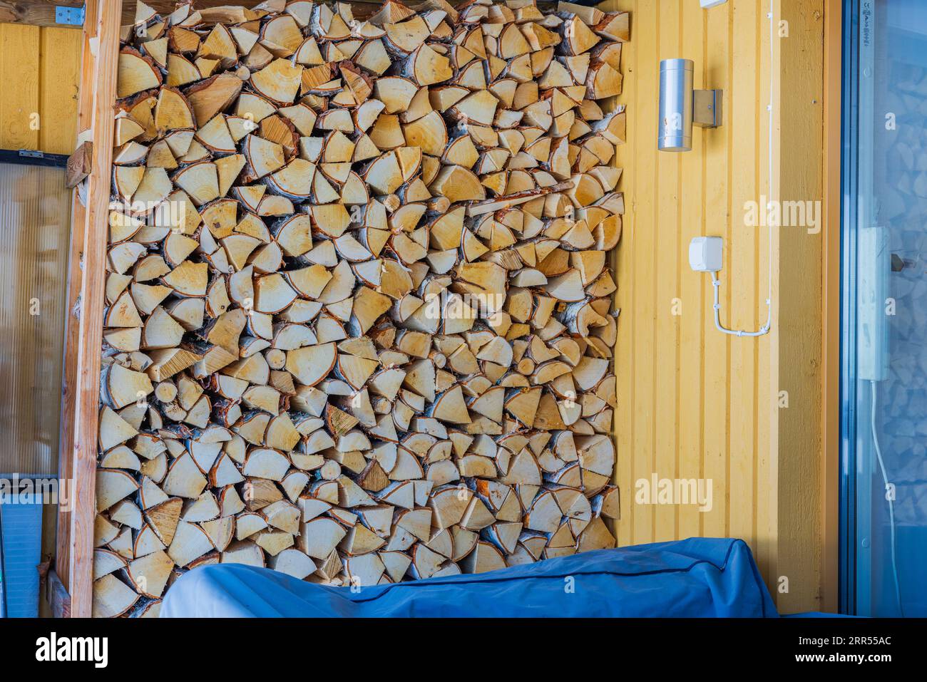 Close-up view of firewood rack prepared for cold season. Stock Photo