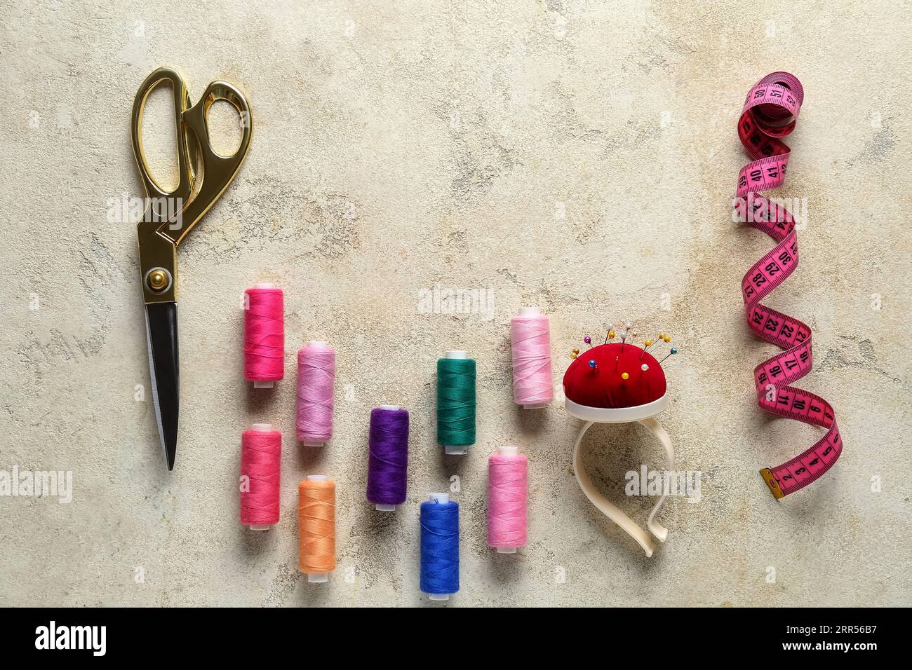 Composition with different sewing supplies on grunge background Stock Photo