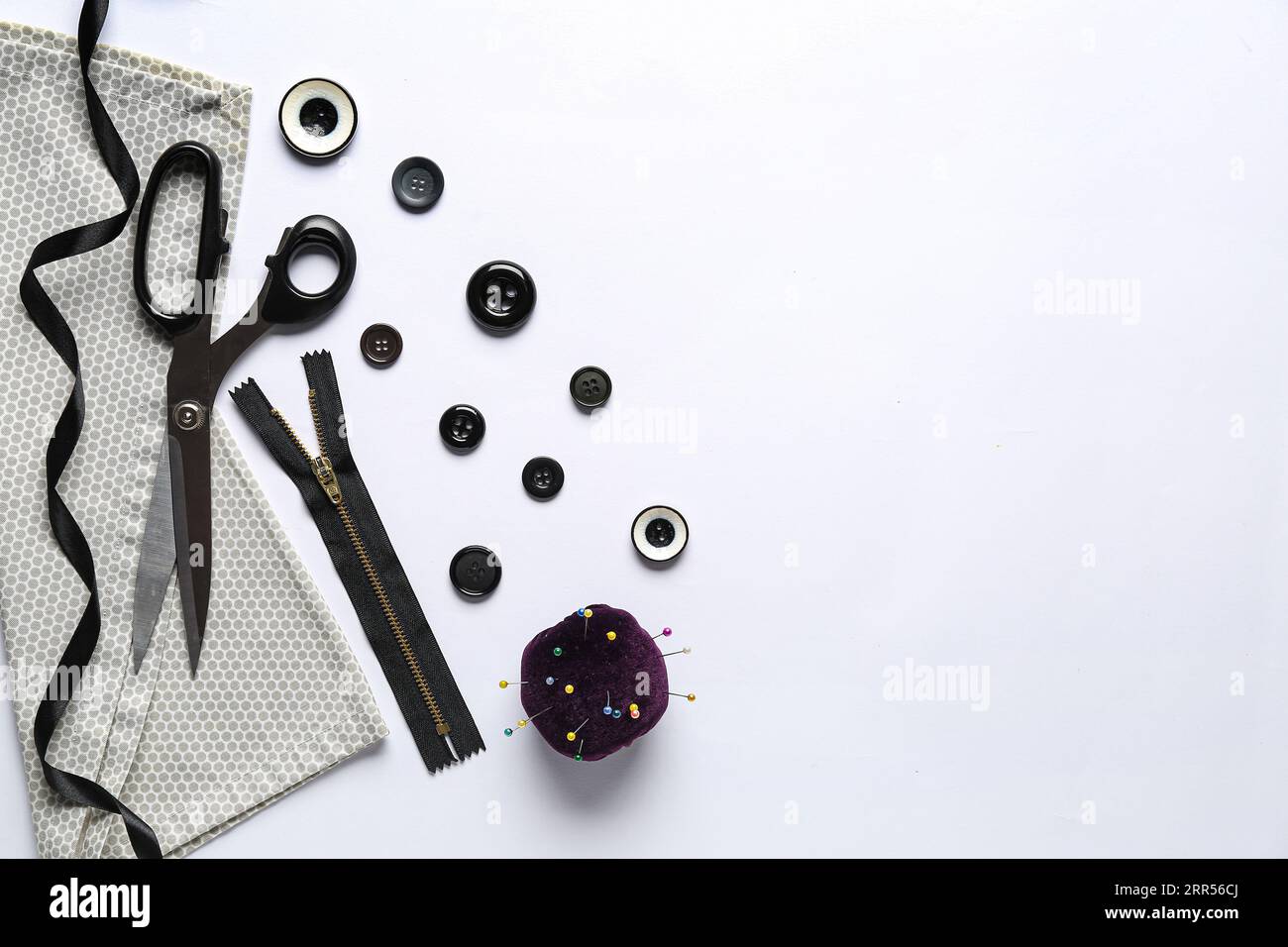 Composition with different sewing supplies on light background Stock Photo