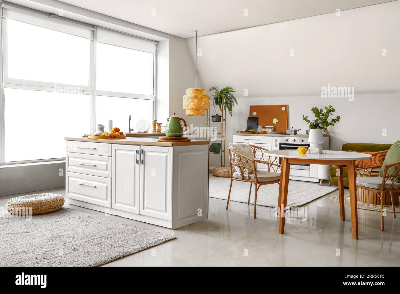 Interior of modern kitchen with white counters and dining table Stock ...