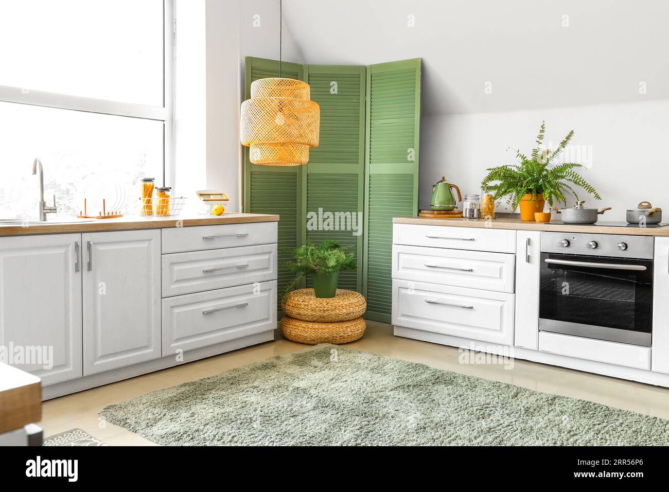 Interior of modern kitchen with white counters and houseplants Stock ...