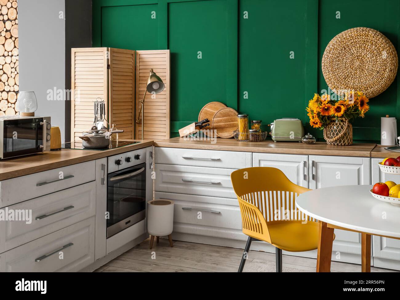 Interior of modern kitchen with white counters and dining table Stock ...
