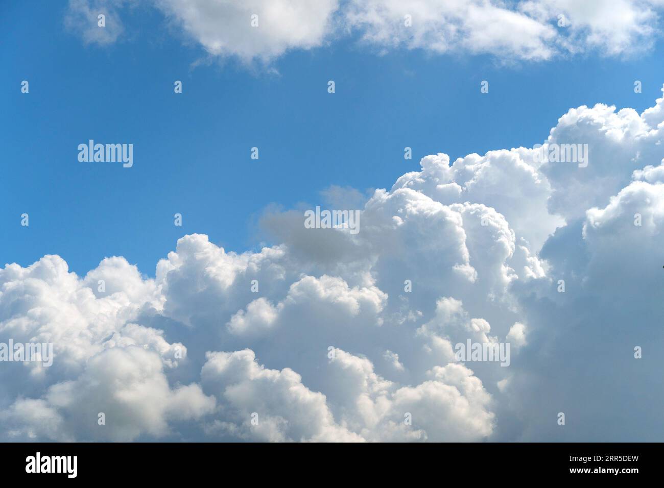 Large, white cumulus cloud against a blue sky Stock Photo
