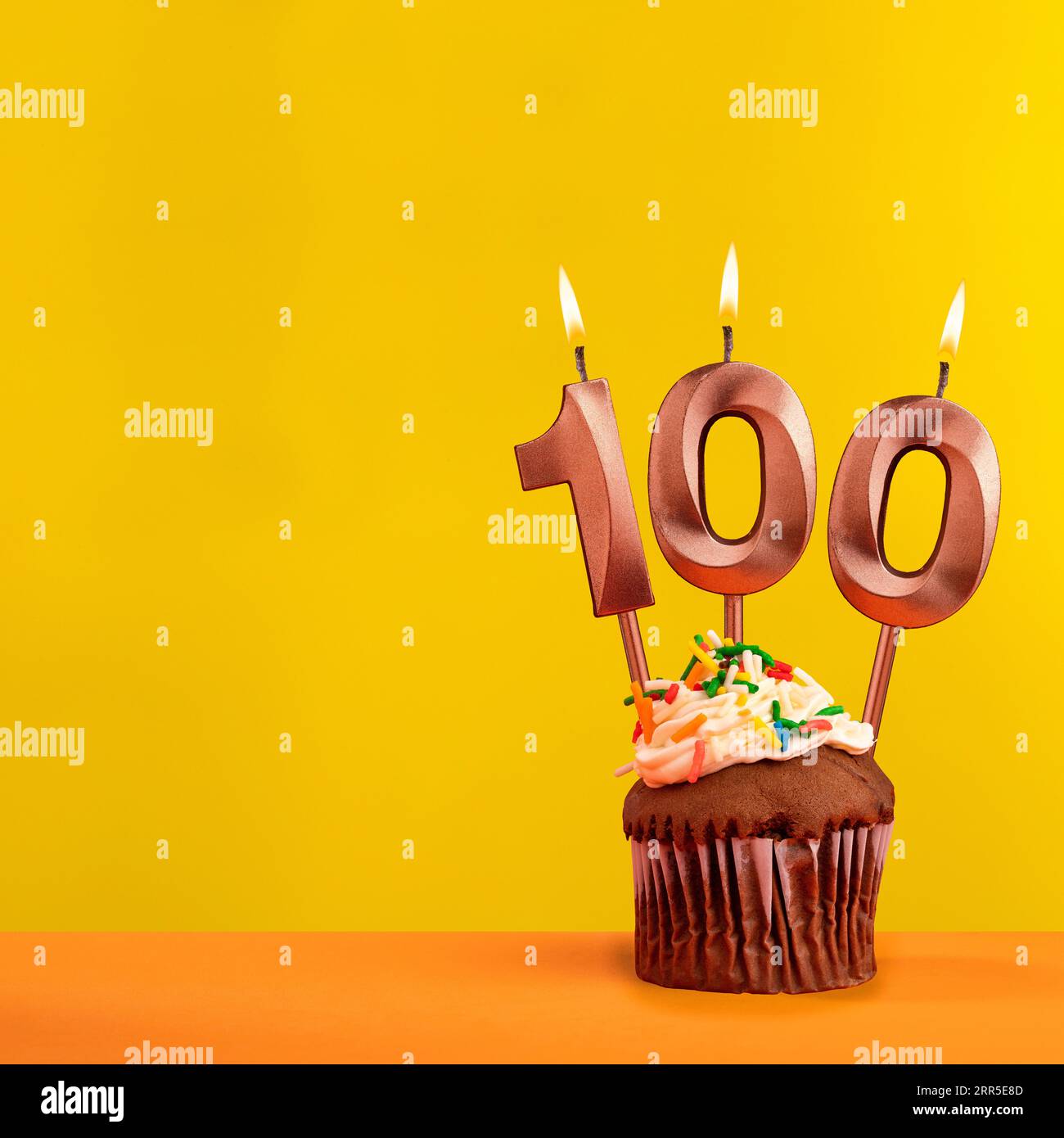 Number 100 birthday candle - Celebration on yellow background Stock ...