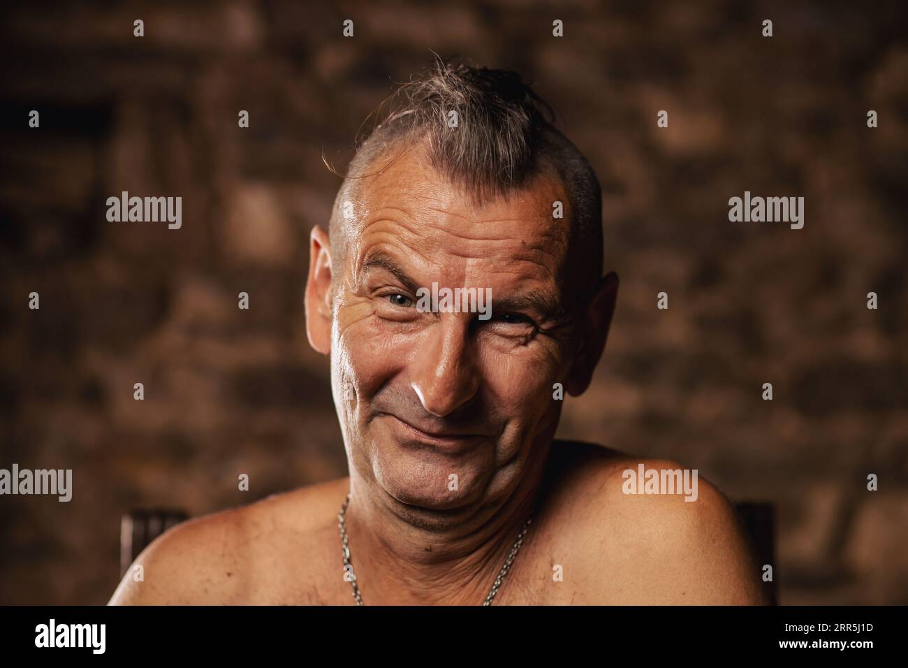 A satisfied older man, sixty years old, smiles and looks at the camera Stock Photo Alamy