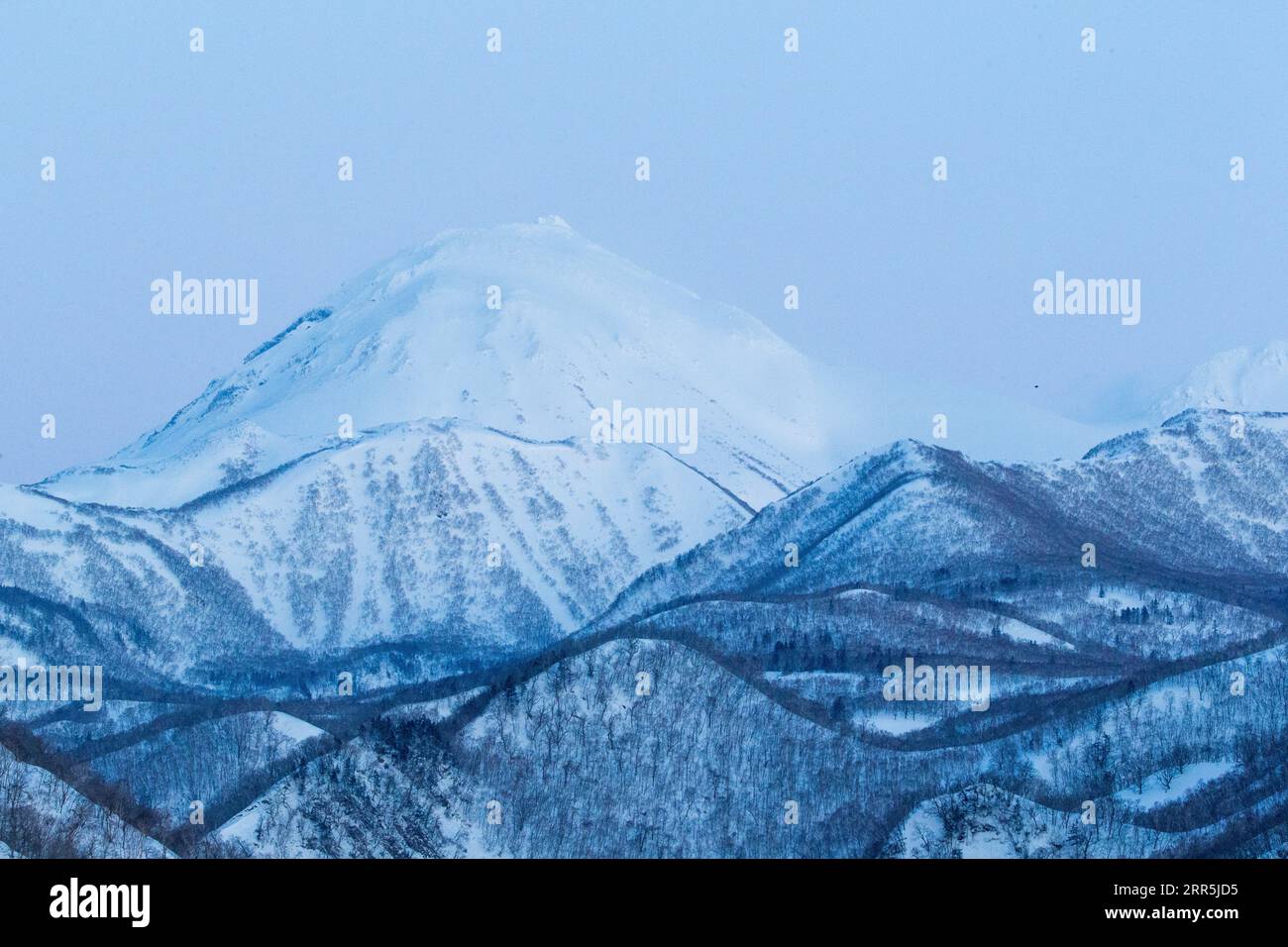 Mountain scenery of the island Hokkaido. Many hills and large mountains covered with snow. Hokkaido island, Japan Stock Photo