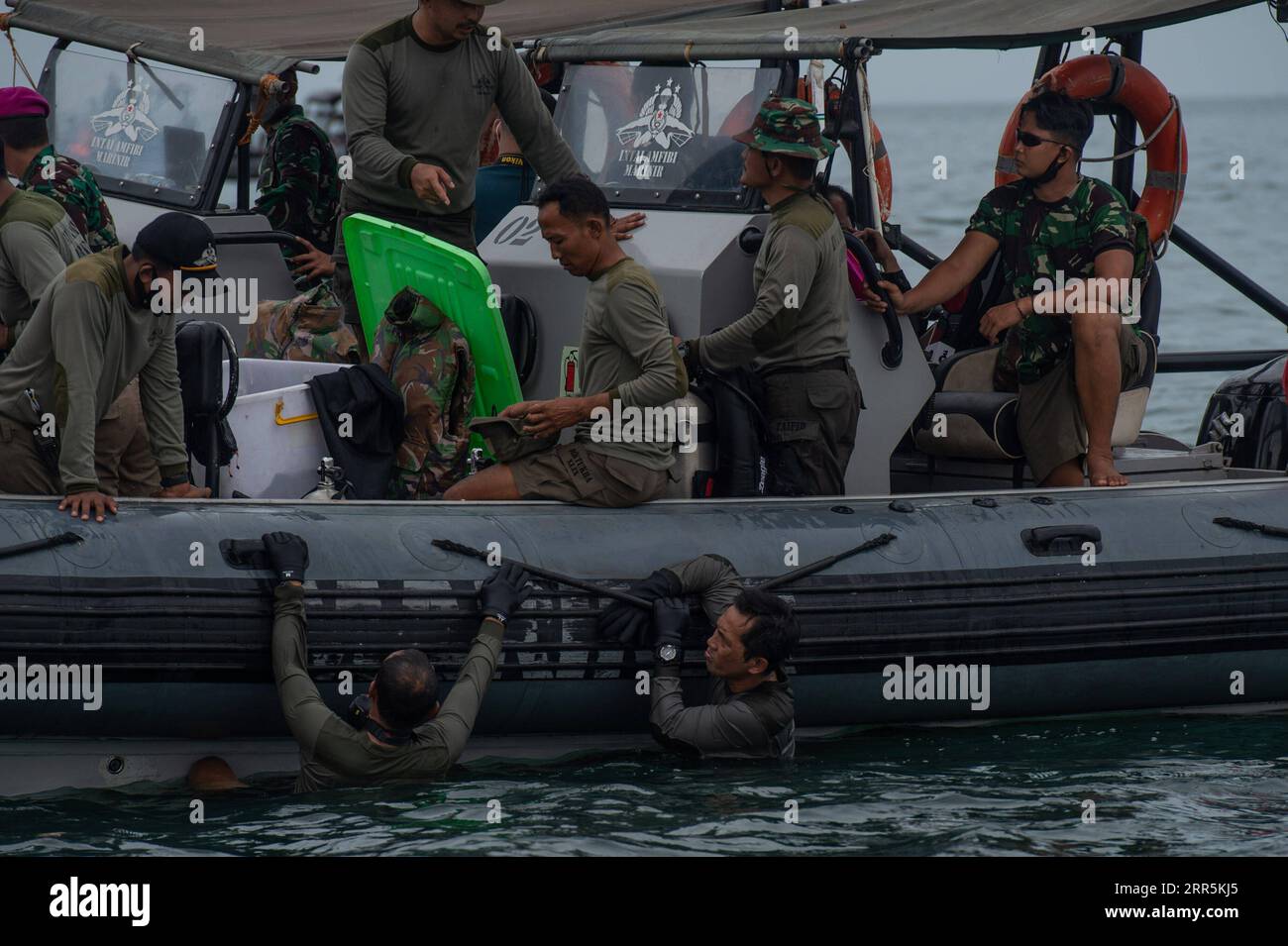210110 -- LANCANG ISLAND, Jan. 10, 2021 -- Navy special force conducts a search operation at the plane crash site of the Sriwijaya Air flight SJ-182 in the waters of Lancang Island, north of Jakarta, Indonesia, Jan. 10, 2021. Indonesian authorities said on Sunday that they have found body parts and stuffs suspected to belong to passengers of Indonesia s Sriwijaya Air plane that crashed into waters off Jakarta. Ships and aircraft from various Indonesian agencies have been involved in the search for the Boeing 737-500 plane which crashed shortly after takeoff with 62 people aboard on Saturday. Stock Photo