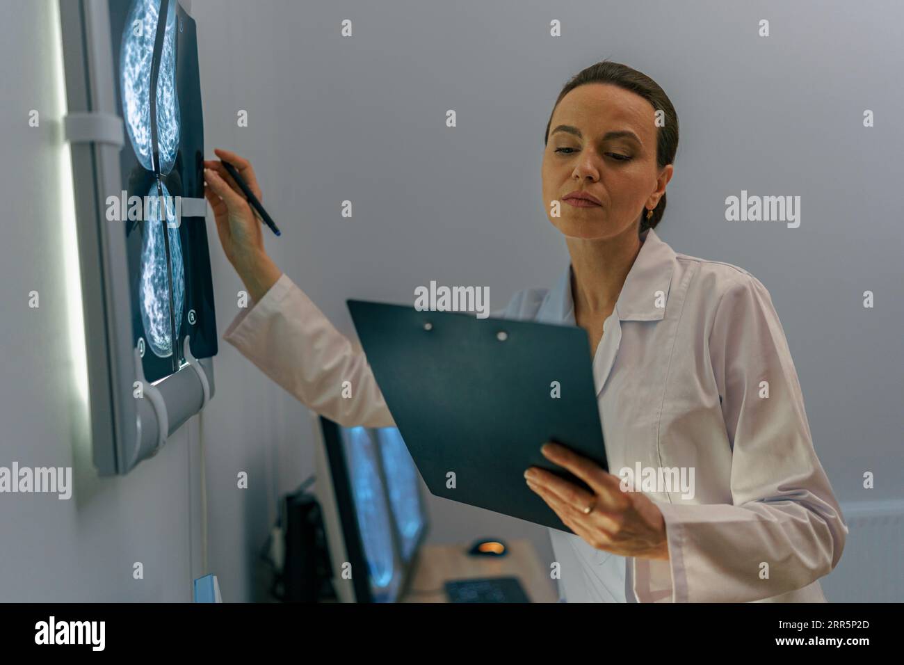 Focused professional doctor radiologist analyzing scan MRI images in ...