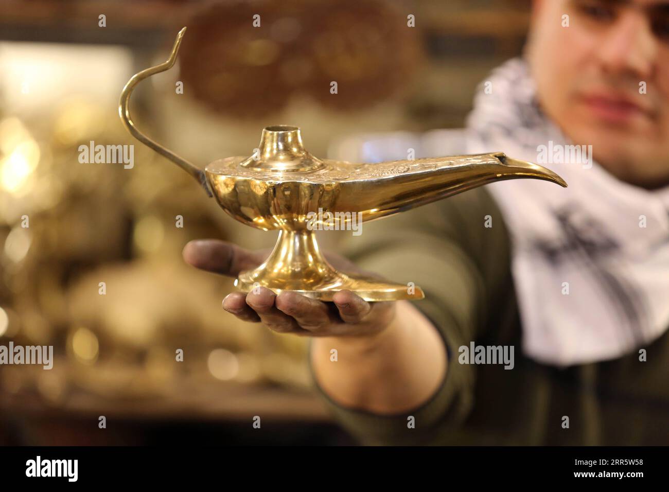 210116 BAGHDAD, Jan. 16, 2021 A coppersmith holds a lamp similar to the famous Aladdin