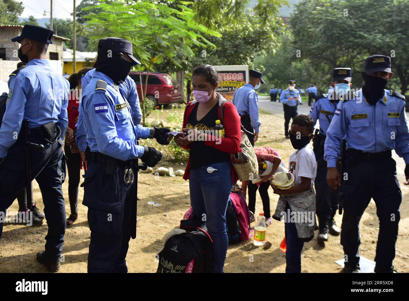 210118 -- TEGUCIGALPA, Jan. 18, 2021  -- A migrant woman shows the police her credentials in Cofradia, Honduras, Jan. 15, 2021. Guatemalan security forces clashed with a caravan of Honduran migrants crossing the country en route to the United States on Sunday in Vado Hondo, Chiquimula, 177 km east of Guatemala City, migration authorities said. On Saturday night, Guatemalan authorities intercepted 992 migrants at the border, some of whom were detained and others deported to Honduras.  HONDURAS-TEGUCIGALPA-MIGRANTS Xinhua PUBLICATIONxNOTxINxCHN Stock Photo