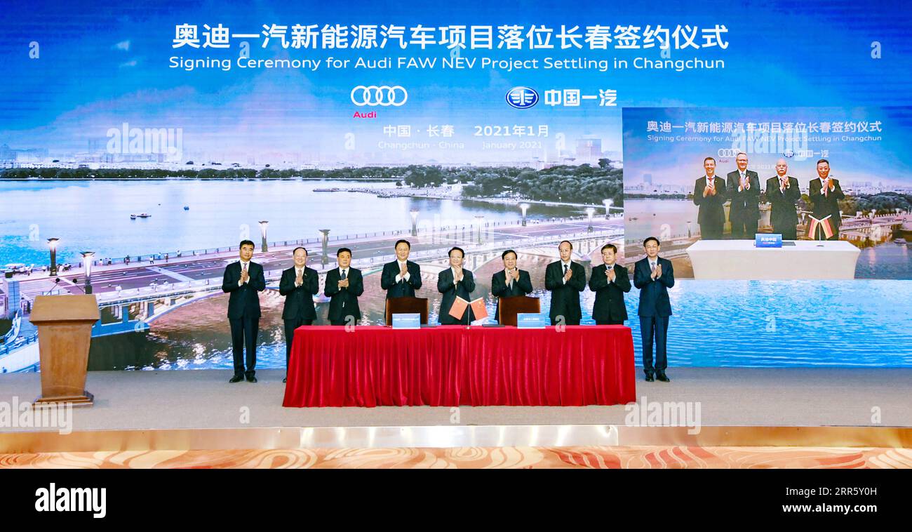 210118 -- CHANGCHUN, Jan. 18, 2021  -- Photo taken on Jan. 18, 2021 shows representatives of China s leading automaker First Automotive Works FAW, German automaker Audi, and the Changchun government signing an agreement to launch a project to produce electric vehicles in Changchun, northeast China s Jilin Province. The three sides signed an agreement via video on Monday. The project plans to introduce the Premium Platform Electric PPE. The first factory will invest more than 30 billion yuan 4.62 billion U.S. dollars under the project. The first car model will go into production in 2024 in Chan Stock Photo