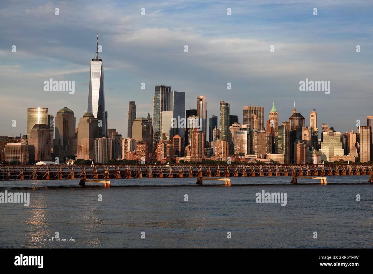 The skyline of Manhattan as seen from across the Hudson in New Jersey features such iconic buildings as Chrysler, Empire State and Freedom Tower Stock Photo
