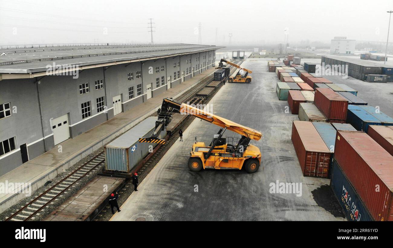 210122 -- JINAN, Jan. 22, 2021 -- Aerial photo taken on Jan. 21, 2021 shows staff members of the China Railway Jinan Group Co., Ltd. moving cargo for trains to Europe and other parts of Asia in Dongjiazhen Township of Jinan City, capital of east China s Shandong Province. The China Railway Jinan Group Co., Ltd. has been boosting the business of its Qilu freight trains to Europe and other parts of Asia by steadily streamlining cargo flows in recent years. A total of 1,506 Qilu trains left Shandong in 2020, a year-on-year growth of 42.9 percent. These trains have served as accelerators to Shando Stock Photo