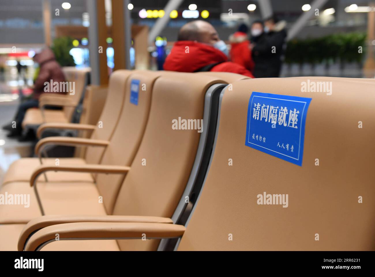 210122 -- BEIJING, Jan. 22, 2021 -- Signs reminding people to sit by distance are seen at the waiting hall of Beijing Chaoyang Railway Station in Beijing, capital of China, Jan. 22, 2021. China on Friday launched a new high-speed railway service that connects Beijing with Harbin, capital of the northeastern province of Heilongjiang. A newly unveiled 192-km-long section, running from Beijing to Chengde, in the neighboring Hebei Province, started operation Friday morning. Combined with two previously opened sections, the Beijing-Harbin high-speed railway extends 1,198 km. The new railway service Stock Photo