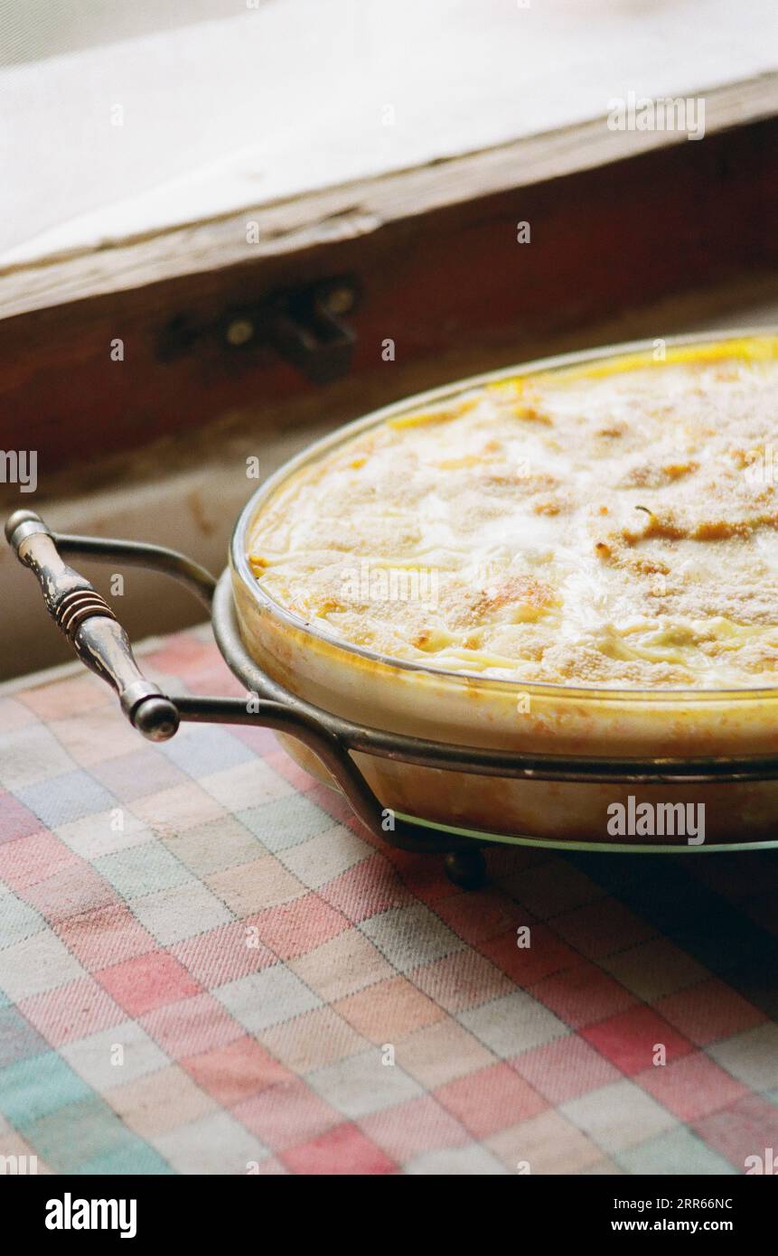 Salt cod pie cooling on kitchen table Stock Photo