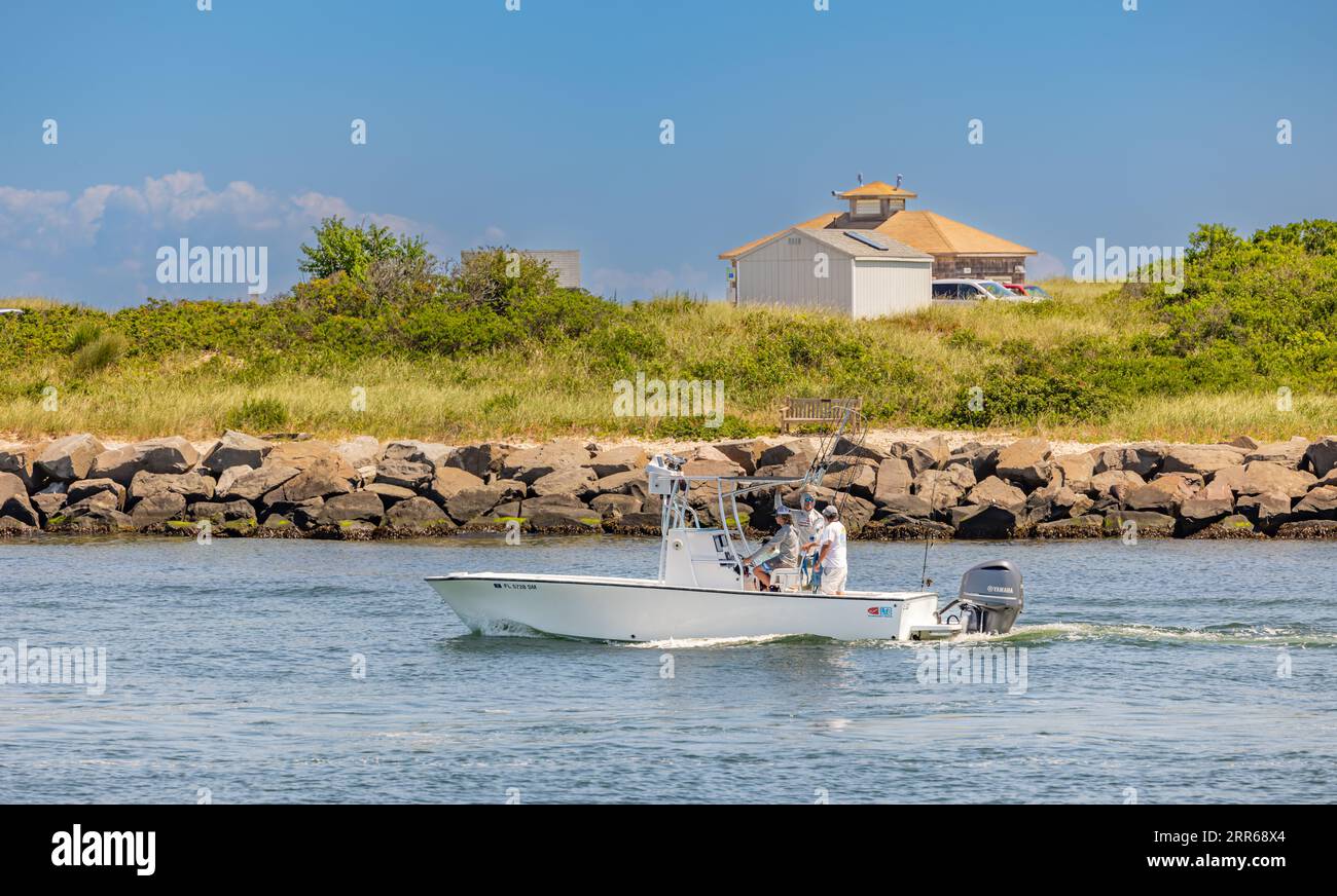 group of guys heading out of montauk on a small motorboat Stock Photo