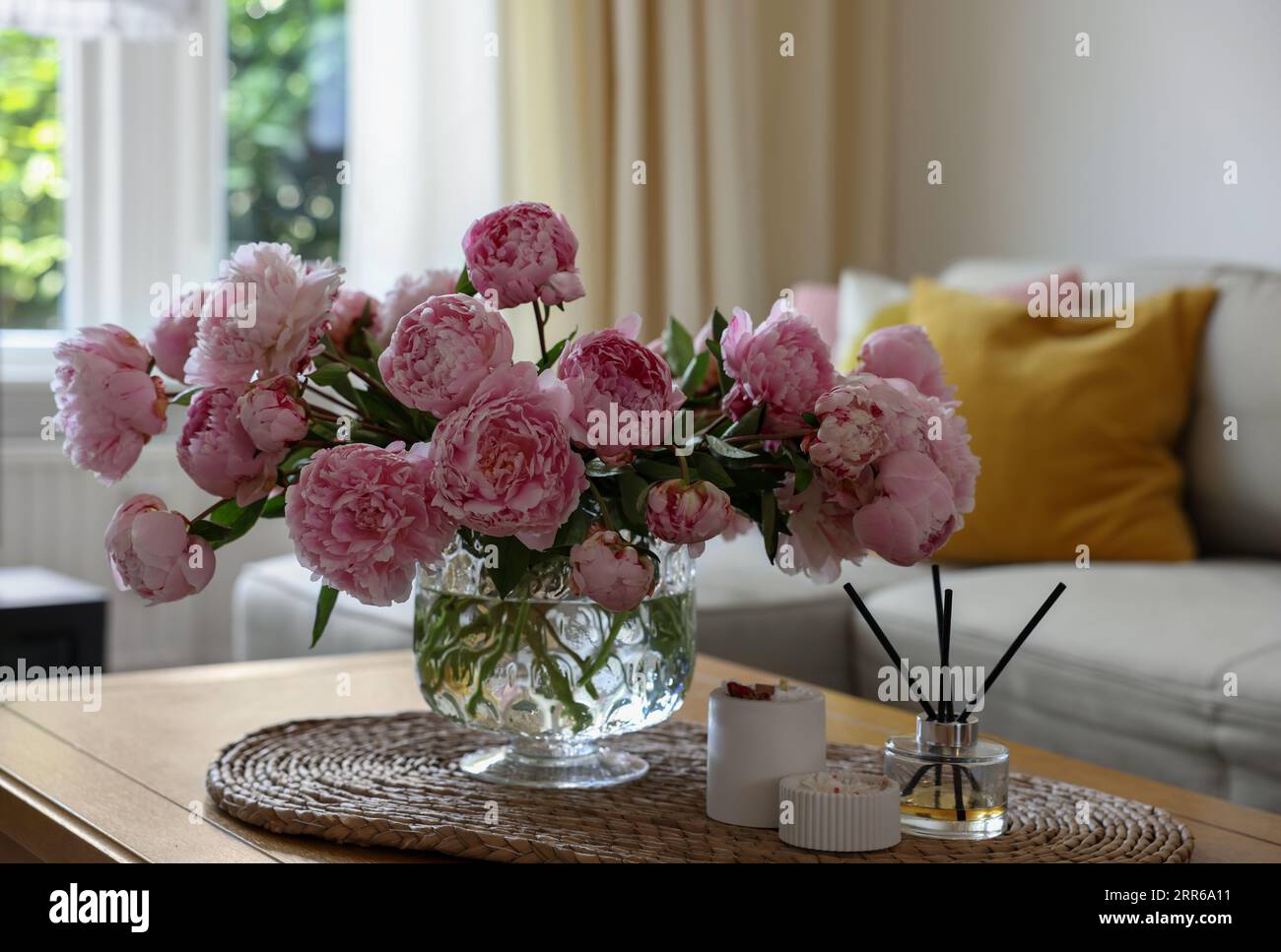 Beautiful pink peonies in vase on table at home. Interior design Stock ...