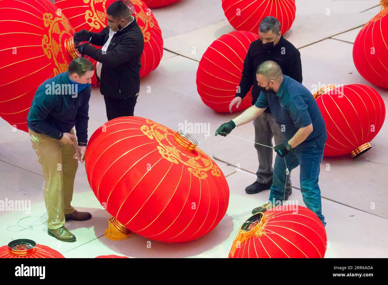 210202 -- DALLAS U.S., Feb. 2, 2021 -- Staff members install red lanterns in Galleria Dallas shopping mall in Dallas, Texas, the United States, on Feb. 2, 2021. Over 200 red lanterns, as decorations for the upcoming Chinese Lunar New Year, are hung above the shopping mall s ice skating rink from Feb. 2 to March 2. Photo by /Xinhua U.S.-TEXAS-DALLAS-CHINESE LUNAR NEW YEAR-DECORATIONS DanxTian PUBLICATIONxNOTxINxCHN Stock Photo