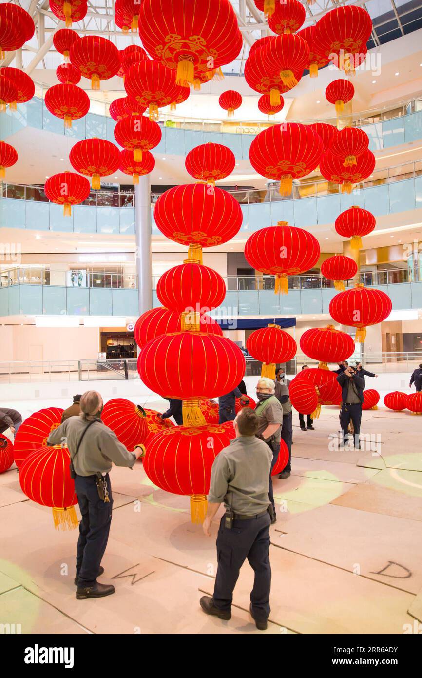 210202 -- DALLAS U.S., Feb. 2, 2021 -- Staff members install red lanterns in Galleria Dallas shopping mall in Dallas, Texas, the United States, on Feb. 2, 2021. Over 200 red lanterns, as decorations for the upcoming Chinese Lunar New Year, are hung above the shopping mall s ice skating rink from Feb. 2 to March 2. Photo by /Xinhua U.S.-TEXAS-DALLAS-CHINESE LUNAR NEW YEAR-DECORATIONS DanxTian PUBLICATIONxNOTxINxCHN Stock Photo