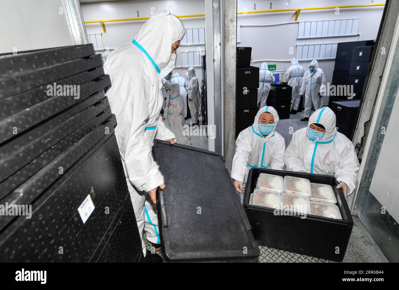 210203 -- TONGHUA, Feb. 3, 2021 -- Distribution workers load boxed meals onto a truck in Jiahe Catering Company in Tonghua City of northeast China s Jilin Province, Jan. 21, 2021. The city is slowing down to curb the pandemic, but we re not closing up. Instead, we re busier than ever, said Zhao Hongxia, general manager of Jiahe Catering Company. The company was originally a boxed meal supplier for primary and secondary schools in Tonghua City. Since the COVID-19 outbreak in Tonghua, the company has accepted a new task of providing meals to front-line staff and people under quarantine. More tha Stock Photo