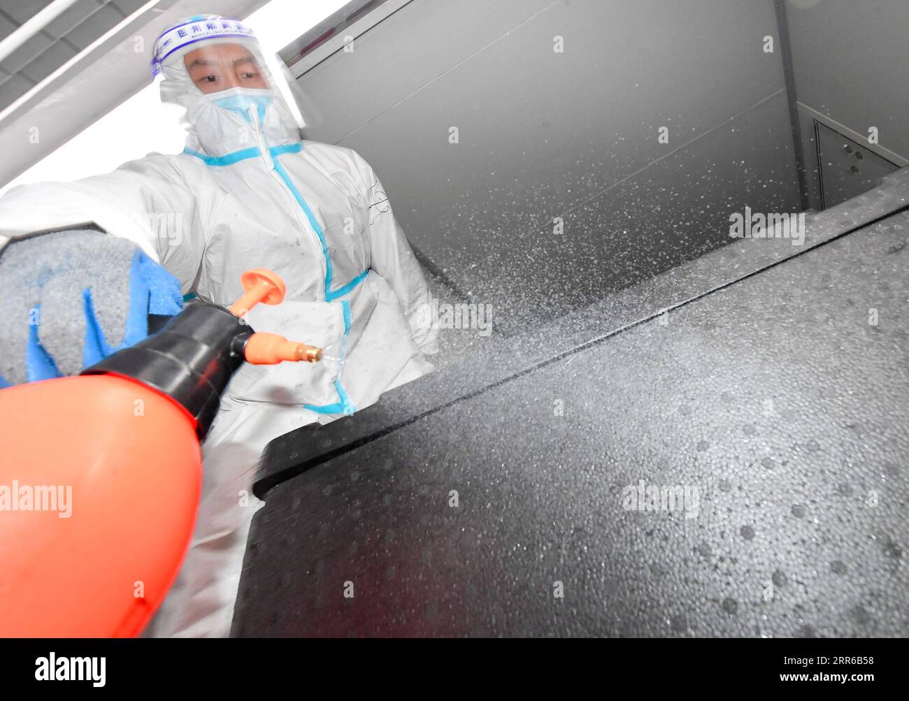 210203 -- TONGHUA, Feb. 3, 2021 -- A worker disinfects a transportable container for boxed meals in Tonghua City of northeast China s Jilin Province, Jan. 21, 2021. The city is slowing down to curb the pandemic, but we re not closing up. Instead, we re busier than ever, said Zhao Hongxia, general manager of Jiahe Catering Company. The company was originally a boxed meal supplier for primary and secondary schools in Tonghua City. Since the COVID-19 outbreak in Tonghua, the company has accepted a new task of providing meals to front-line staff and people under quarantine. More than 30,000 boxes Stock Photo