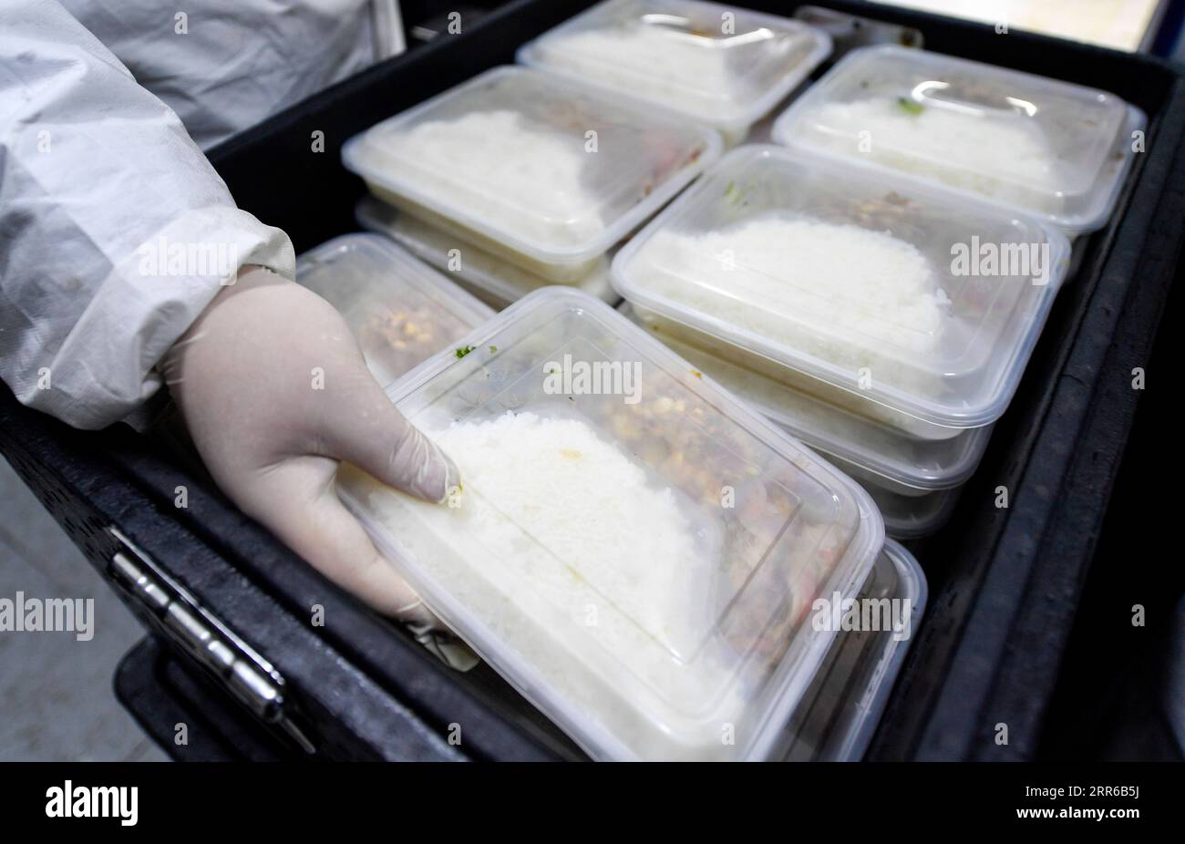 210203 -- TONGHUA, Feb. 3, 2021 -- Distribution workers package boxed meals in Jiahe Catering Company in Tonghua City of northeast China s Jilin Province, Jan. 21, 2021. The city is slowing down to curb the pandemic, but we re not closing up. Instead, we re busier than ever, said Zhao Hongxia, general manager of Jiahe Catering Company. The company was originally a boxed meal supplier for primary and secondary schools in Tonghua City. Since the COVID-19 outbreak in Tonghua, the company has accepted a new task of providing meals to front-line staff and people under quarantine. More than 30,000 b Stock Photo