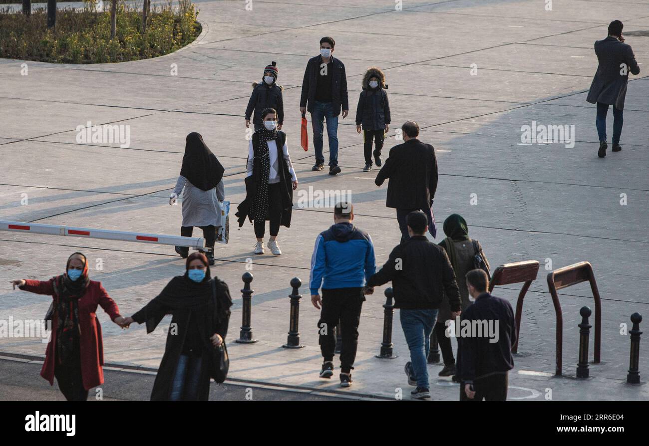 210209 -- TEHRAN, Feb. 9, 2021 -- Pedestrians with face masks walk on a street in Tehran, Iran, on Feb. 8, 2021. Iran s Health Ministry reported 7,321 daily COVID-19 cases on Monday, raising the total nationwide infections to 1,473,756. The pandemic has so far claimed 58,536 lives in Iran, up by 67 in the past 24 hours, said Sima Sadat Lari, the spokeswoman for Iranian Ministry of Health and Medical Education, during her daily briefing. Photo by /Xinhua IRAN-TEHRAN-COVID-19 AhmadxHalabisaz PUBLICATIONxNOTxINxCHN Stock Photo