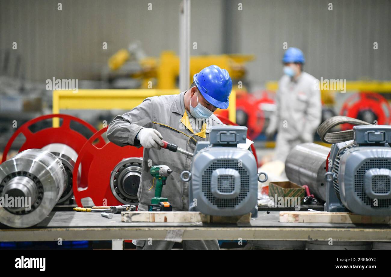 210215 -- TIANJIN, Feb. 15, 2021 -- A laborer works at a workshop of AE Tianjin Automotive Equipment Co., Ltd. in Tianjin, north China, Feb. 14, 2021. About 300 production workers of this company chose to stay put at their working position during this year s Spring Festival. Photo by /Xinhua CHINA-TIANJIN-LUNAR NEW YEAR-PRODUCTION WORKERS CN SunxFanyue PUBLICATIONxNOTxINxCHN Stock Photo