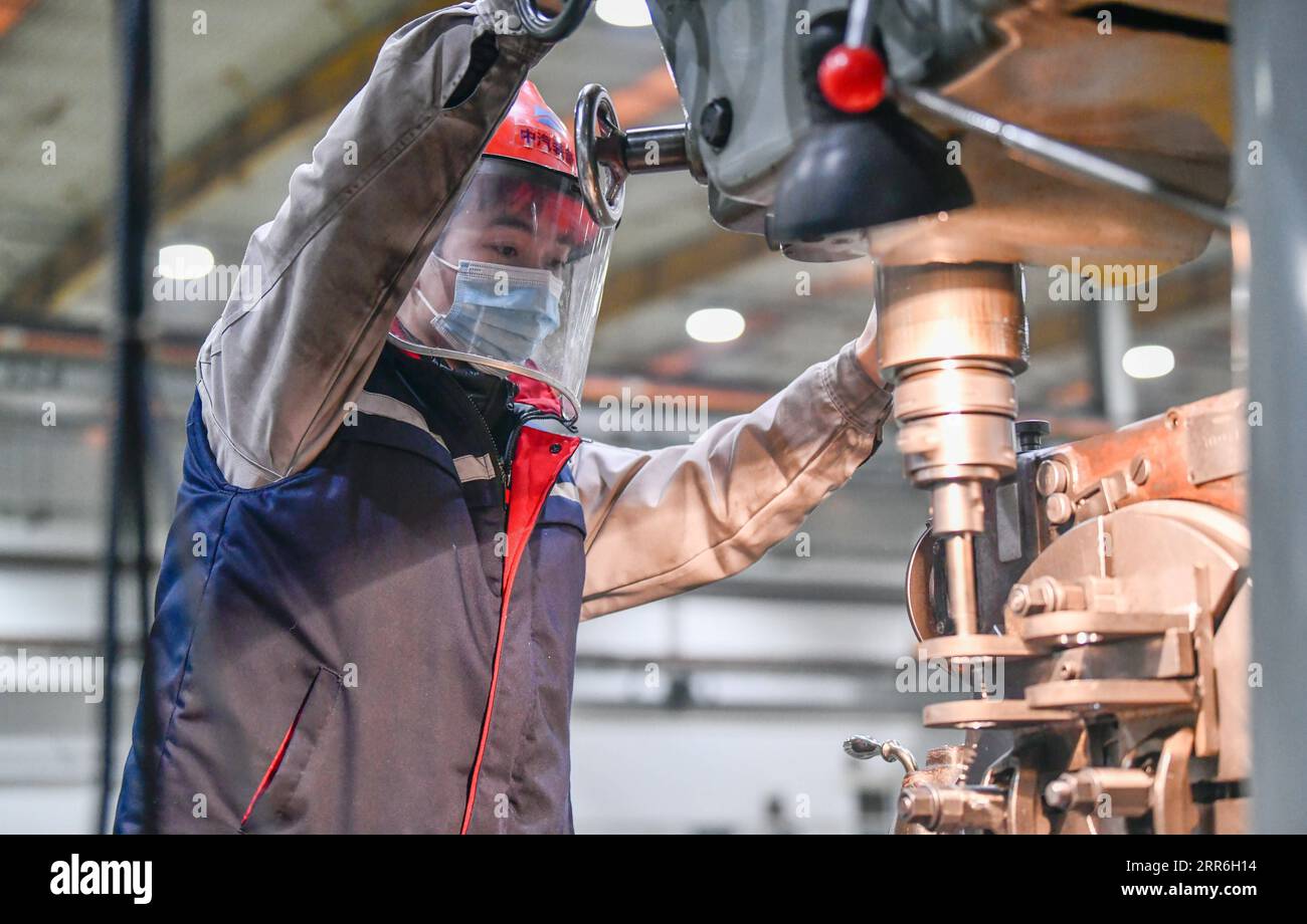 210215 -- TIANJIN, Feb. 15, 2021 -- A laborer works at a workshop of AE Tianjin Automotive Equipment Co., Ltd. in Tianjin, north China, Feb. 14, 2021. About 300 production workers of this company chose to stay put at their working position during this year s Spring Festival. Photo by /Xinhua CHINA-TIANJIN-LUNAR NEW YEAR-PRODUCTION WORKERS CN SunxFanyue PUBLICATIONxNOTxINxCHN Stock Photo
