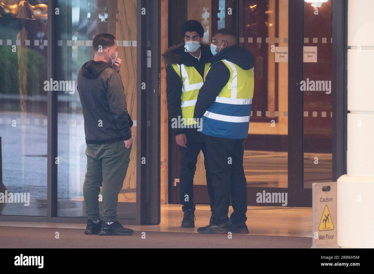 210216 -- LONDON, Feb. 16, 2021 -- Security staff guard the entrance of the Radisson Blu Edwardian Hotel in London, Britain, on Feb. 15, 2021. From Monday, all British and Irish citizens and British residents who arrive in England after being in the red list of more than 30 high-risk countries now have to self-isolate in hotels. The red list countries include South Africa, Portugal and South American nations. Photo by /Xinhua BRITAIN-LONDON-COVID-19-HOTEL QUARANTINE STAY RayxTang PUBLICATIONxNOTxINxCHN Stock Photo