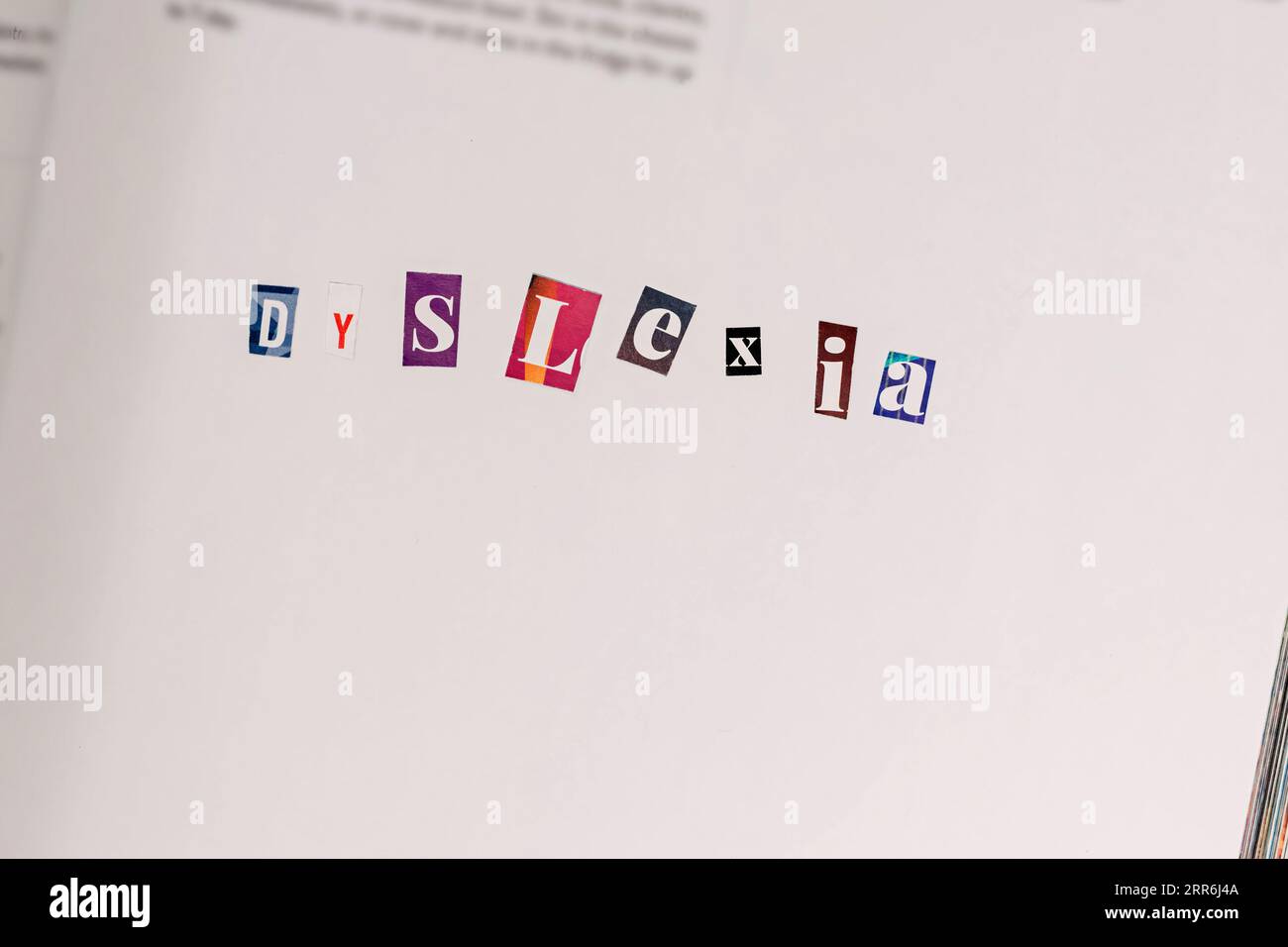 Dyslexia disorder concept, word spelled in colorful paper cut letters