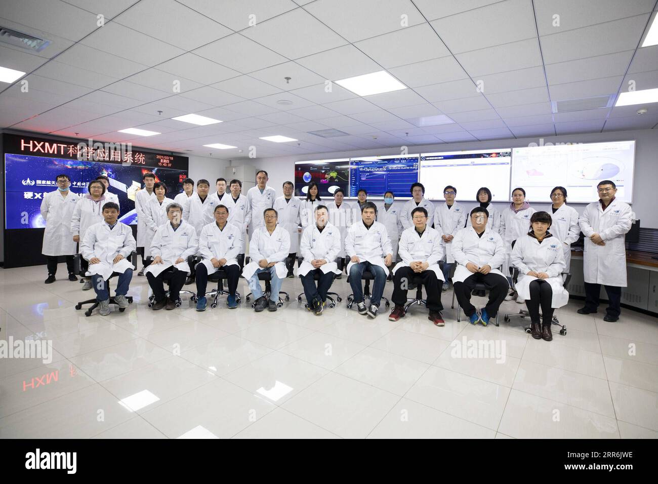 210219 -- BEIJING, Feb. 19, 2021 -- Members of the research team of China s Hard X-ray Modulation Telescope HXMT pose for a group photo at the Institute of High Energy Physics under the Chinese Academy of Sciences in Beijing, capital of China, Feb. 18, 2021. China s HXMT, the country s space science satellite also known as Insight, has found that a fast radio burst signal detected last year came from a magnetar in the Milky Way, Chinese scientists announced Friday. The discovery marked a milestone in understanding the nature of the mysterious signal emanating from the universe, the scientists Stock Photo