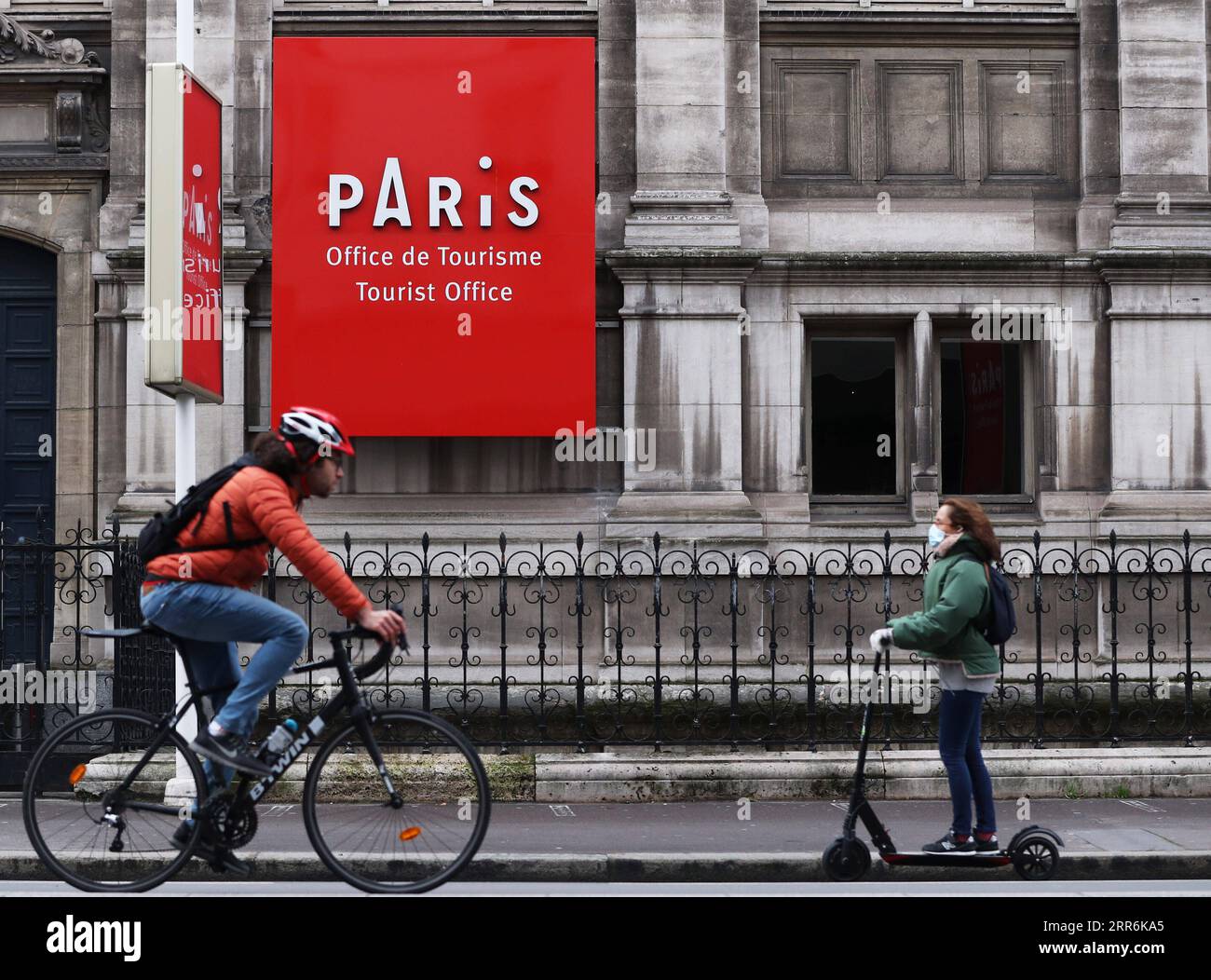 210220 -- PARIS, Feb. 20, 2021 -- People pass by the Tourist Office located in the City Hall of Paris, France, Feb. 19, 2021. With 24,116 new infections confirmed in the last 24 hours, France has counted an accumulative total of 3,560,764 COVID-19 cases as of Friday, according to data from the French Public Health Agency. In a video conference with lawmakers from the ruling The Republic on the Move LERM party, President Emmanuel Macron said it s still too early to decide whether to ease or tighten restrictions. We can consider hypotheses within 8 to 10 days, he was quoted by BFMTV news televis Stock Photo