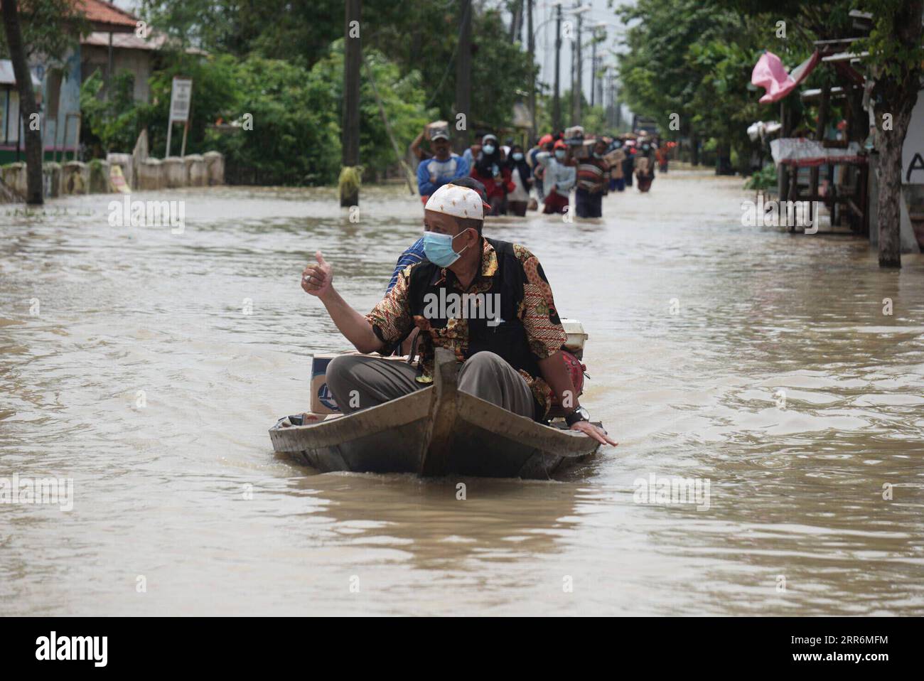 210222 -- WEST JAVA, Feb. 22, 2021 -- A man rides a boat through flood water due to high intensity of rainfall and the overflow of Citarum River at Bekasi, West Java, Indonesia, Feb. 22, 2021. Photo by /Xinhua INDONESIA-WEST JAVA-FLOOD AryaxManggala PUBLICATIONxNOTxINxCHN Stock Photo