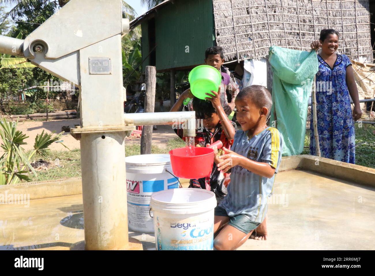210222 -- KAMPONG SPEU, Feb. 22, 2021 -- Children fetch water from a new well constructed under the Phase II of China-aided rural water supply and rural road projects in Cambodia in Kampong Speu Province of Cambodia, Jan. 15, 2021. TO GO WITH Interview: China-aided rural projects playing vital role in improving Cambodia s economy, people s livelihoods: Cambodian official  CAMBODIA-KAMPONG SPEU-CHINA-AID ZhangxZhao PUBLICATIONxNOTxINxCHN Stock Photo