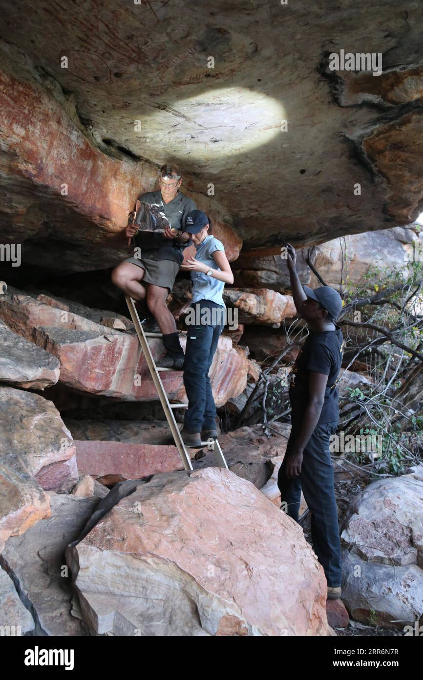 210223 -- SYDNEY, Feb. 23, 2021 -- File photo taken on July 7, 2016 shows researchers recording a painting of a kangaroo in Kimberley region, Australia. A two-meter-long painting of a kangaroo in Western Australia s Kimberley region has been recognized as Australia s oldest intact rock painting, dating back 17,300 years. Naturalistic depictions of animals are a common subject for the world s oldest dated rock art. In a paper published in Nature Human Behavior on Tuesday, a research team led by the University of Melbourne used the radiocarbon dating of 27 mud wasp nests from 16 similar painting Stock Photo