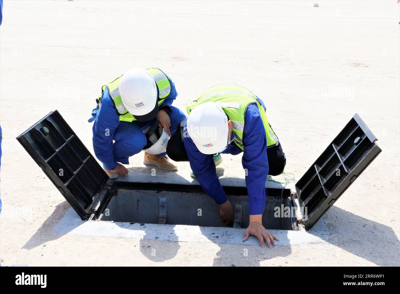210302 -- JAHRA GOVERNORATE, March 2, 2021 -- Staff members work at the construction site of a project of China Gezhouba Group Corporation CGGC in a desert of Jahra Governorate, Kuwait, March 2, 2021. China Gezhouba Group Corporation CGGC, affiliated to China Energy Engineering Group Co., Ltd., handed over on Tuesday the second batch of its housing infrastructure project to the Kuwaiti side, marking the handover of the main works of the project. Photo by Liu Lianghaoyue/Xinhua KUWAIT-JAHRA GOVERNORATE-CHINESE COMPANY-PROJECT-HANDOVER NiexYunpeng PUBLICATIONxNOTxINxCHN Stock Photo
