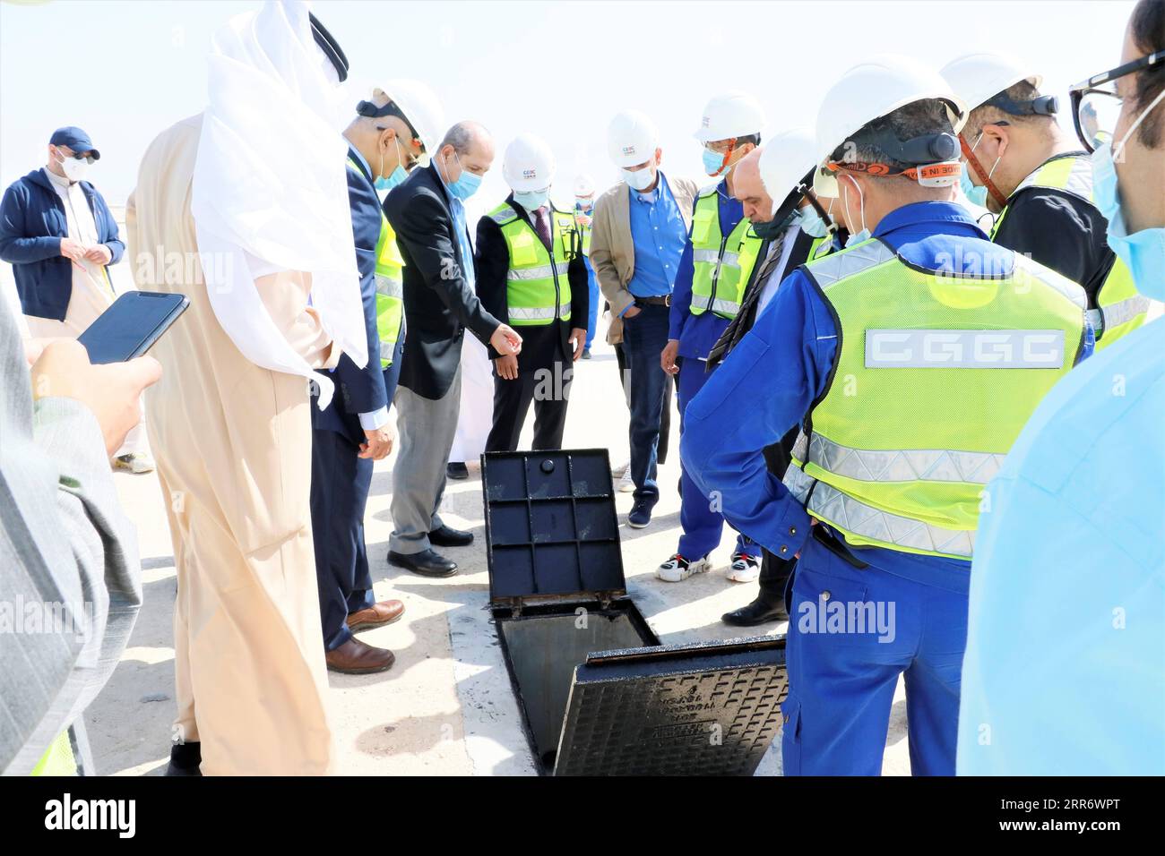 210302 -- JAHRA GOVERNORATE, March 2, 2021 -- Representatives of China Gezhouba Group Corporation CGGC and the Kuwaiti side inspect the construction site of a CGGC project in a desert of Jahra Governorate, Kuwait, March 2, 2021. China Gezhouba Group Corporation CGGC, affiliated to China Energy Engineering Group Co., Ltd., handed over on Tuesday the second batch of its housing infrastructure project to the Kuwaiti side, marking the handover of the main works of the project. Photo by Liu Lianghaoyue/Xinhua KUWAIT-JAHRA GOVERNORATE-CHINESE COMPANY-PROJECT-HANDOVER NiexYunpeng PUBLICATIONxNOTxINxC Stock Photo