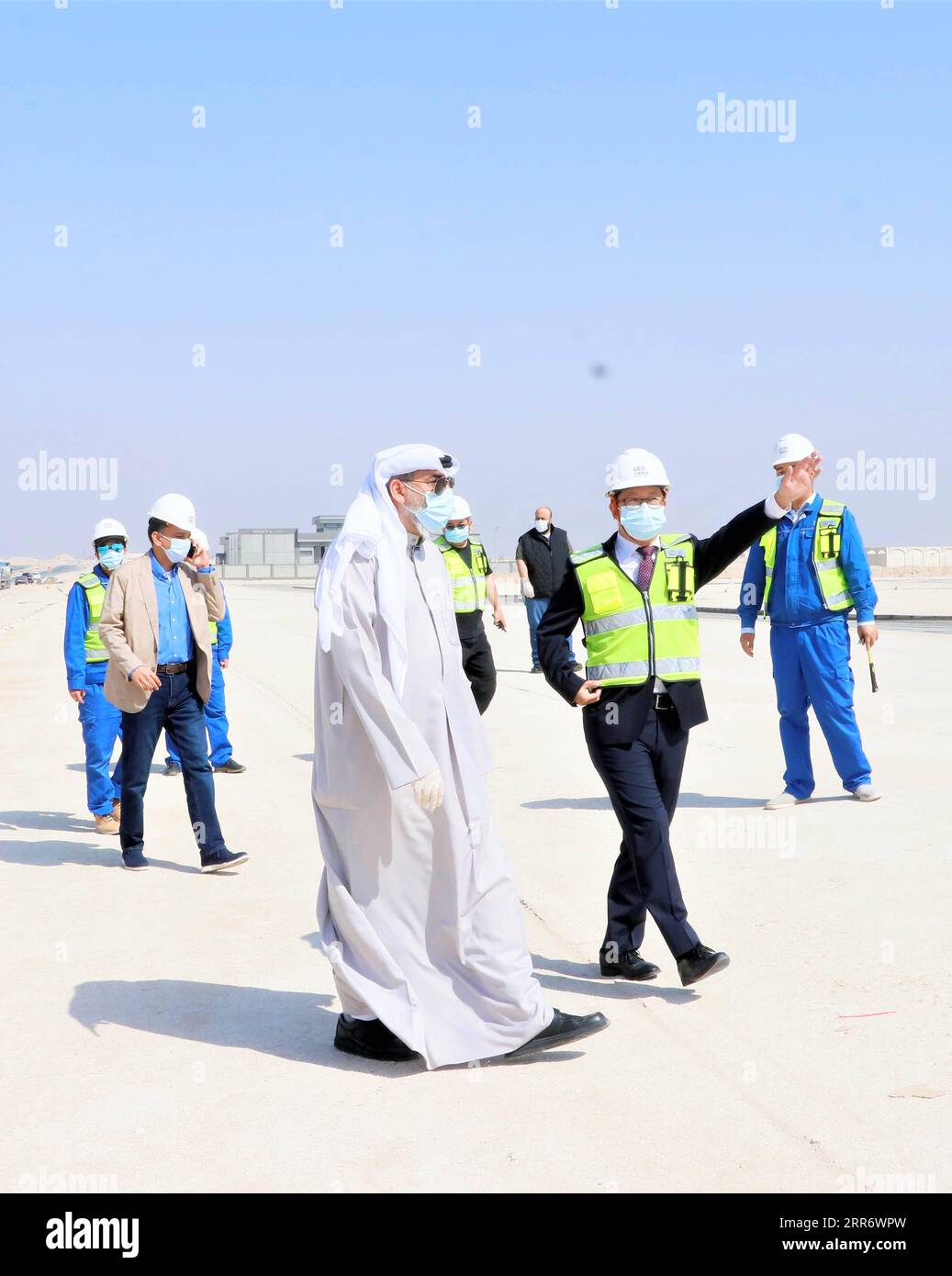 210302 -- JAHRA GOVERNORATE, March 2, 2021 -- Representatives of China Gezhouba Group Corporation CGGC and the Kuwaiti side inspect the construction site of a CGGC project in a desert of Jahra Governorate, Kuwait, March 2, 2021. China Gezhouba Group Corporation CGGC, affiliated to China Energy Engineering Group Co., Ltd., handed over on Tuesday the second batch of its housing infrastructure project to the Kuwaiti side, marking the handover of the main works of the project. Photo by Liu Lianghaoyue/Xinhua KUWAIT-JAHRA GOVERNORATE-CHINESE COMPANY-PROJECT-HANDOVER NiexYunpeng PUBLICATIONxNOTxINxC Stock Photo