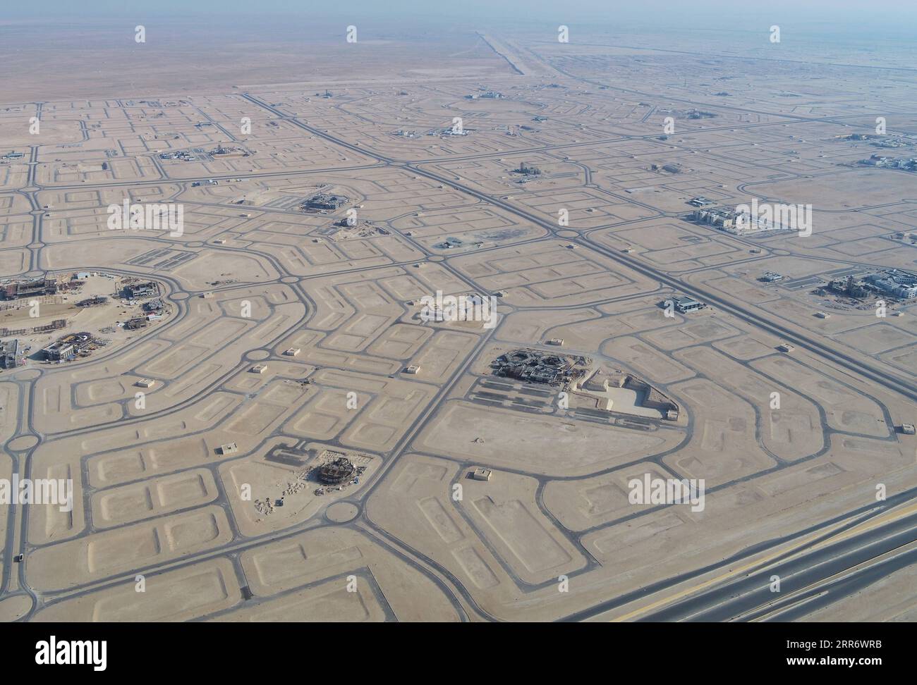210302 -- JAHRA GOVERNORATE, March 2, 2021 -- Aerial photo taken on Feb. 27, 2021 shows the construction site of a project of China Gezhouba Group Corporation CGGC in a desert of Jahra Governorate, Kuwait. China Gezhouba Group Corporation CGGC, affiliated to China Energy Engineering Group Co., Ltd., handed over on Tuesday the second batch of its housing infrastructure project to the Kuwaiti side, marking the handover of the main works of the project. Photo by Chen Cichao/Xinhua KUWAIT-JAHRA GOVERNORATE-CHINESE COMPANY-PROJECT-HANDOVER NiexYunpeng PUBLICATIONxNOTxINxCHN Stock Photo