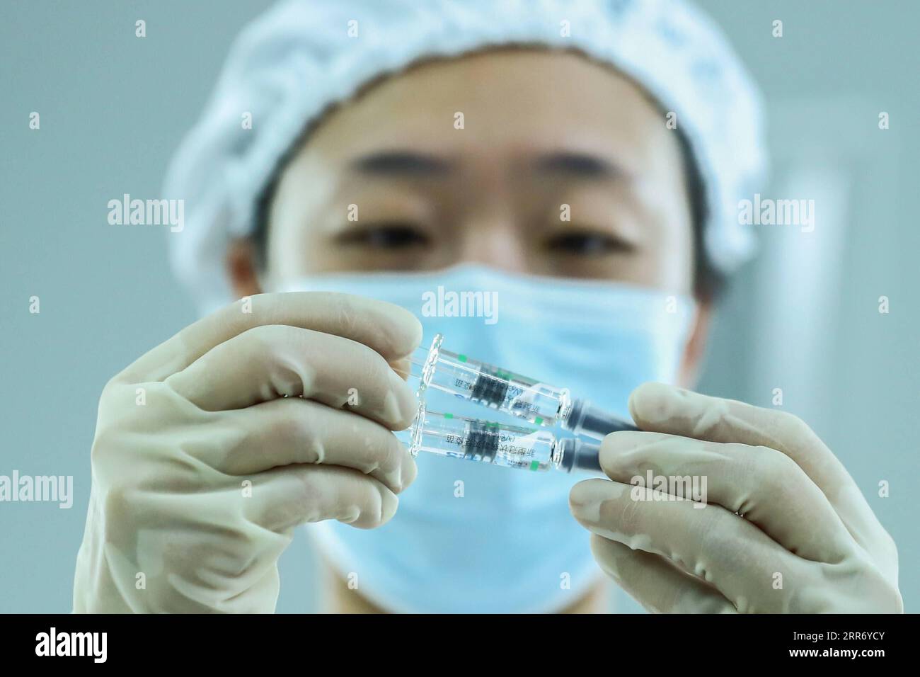210305 -- BEIJING, March 5, 2021 -- A staff member checks the packaging quality of COVID-19 inactivated vaccine products at a packaging plant of the Beijing Biological Products Institute Co., Ltd. in Beijing, capital of China, Dec. 25, 2020.  Xinhua Headlines: China targets GDP growth of over 6 pct in 2021, revs up modernization drive ZhangxYuwei PUBLICATIONxNOTxINxCHN Stock Photo